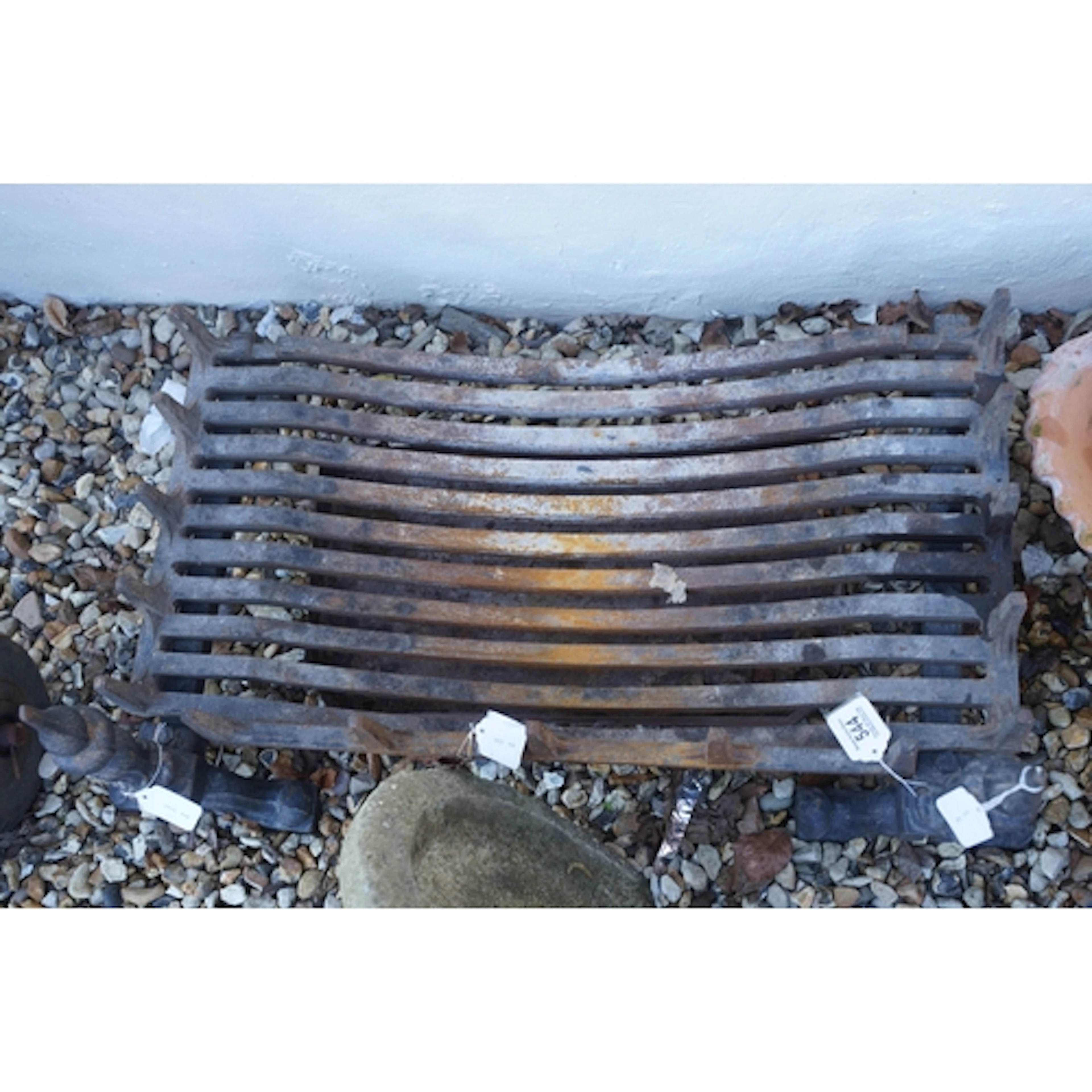 Cast iron fire grate raised on fire dogs with finials, H 39c...
