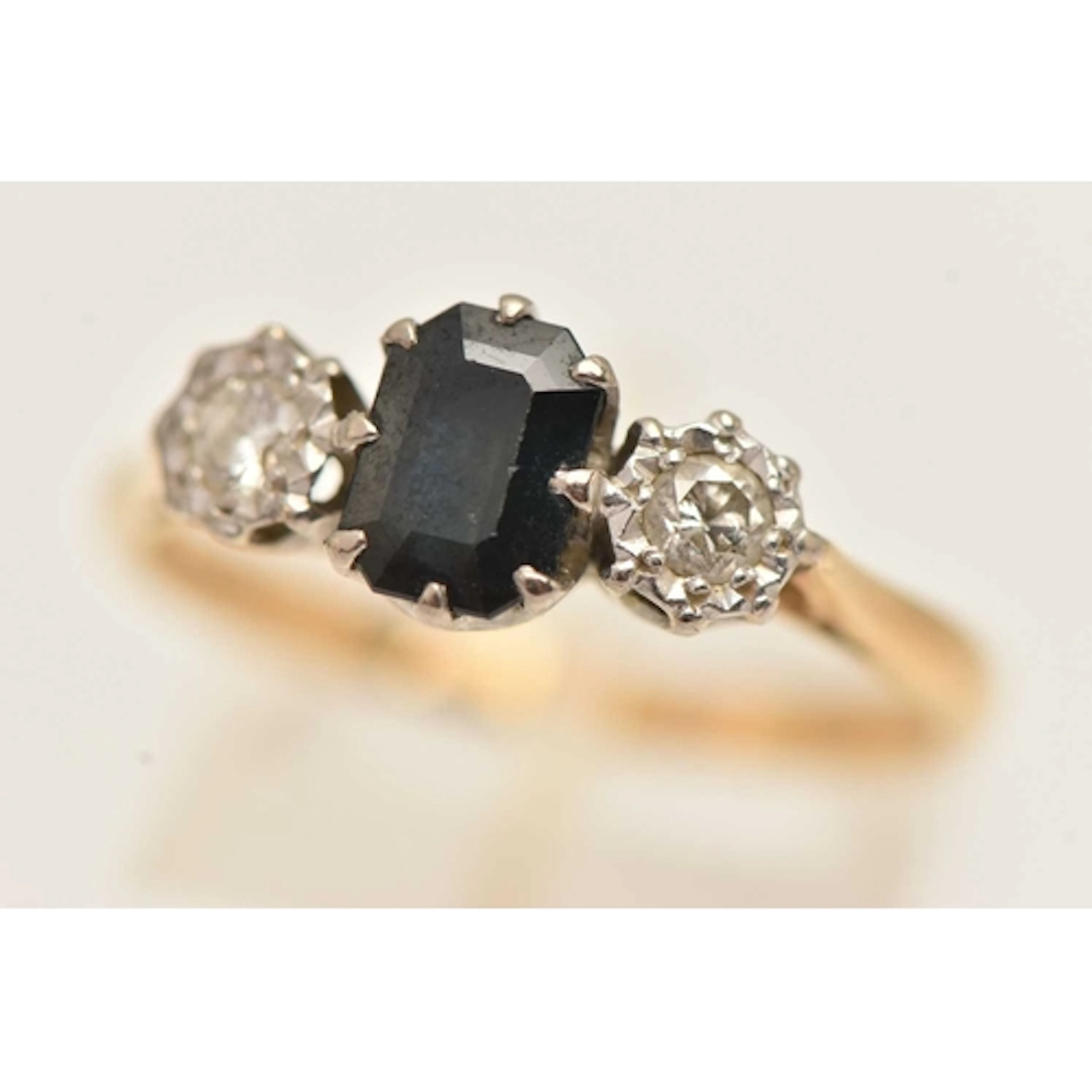 A 14CT GOLD SAPPHIRE AND DIAMOND RING, set with a central re...