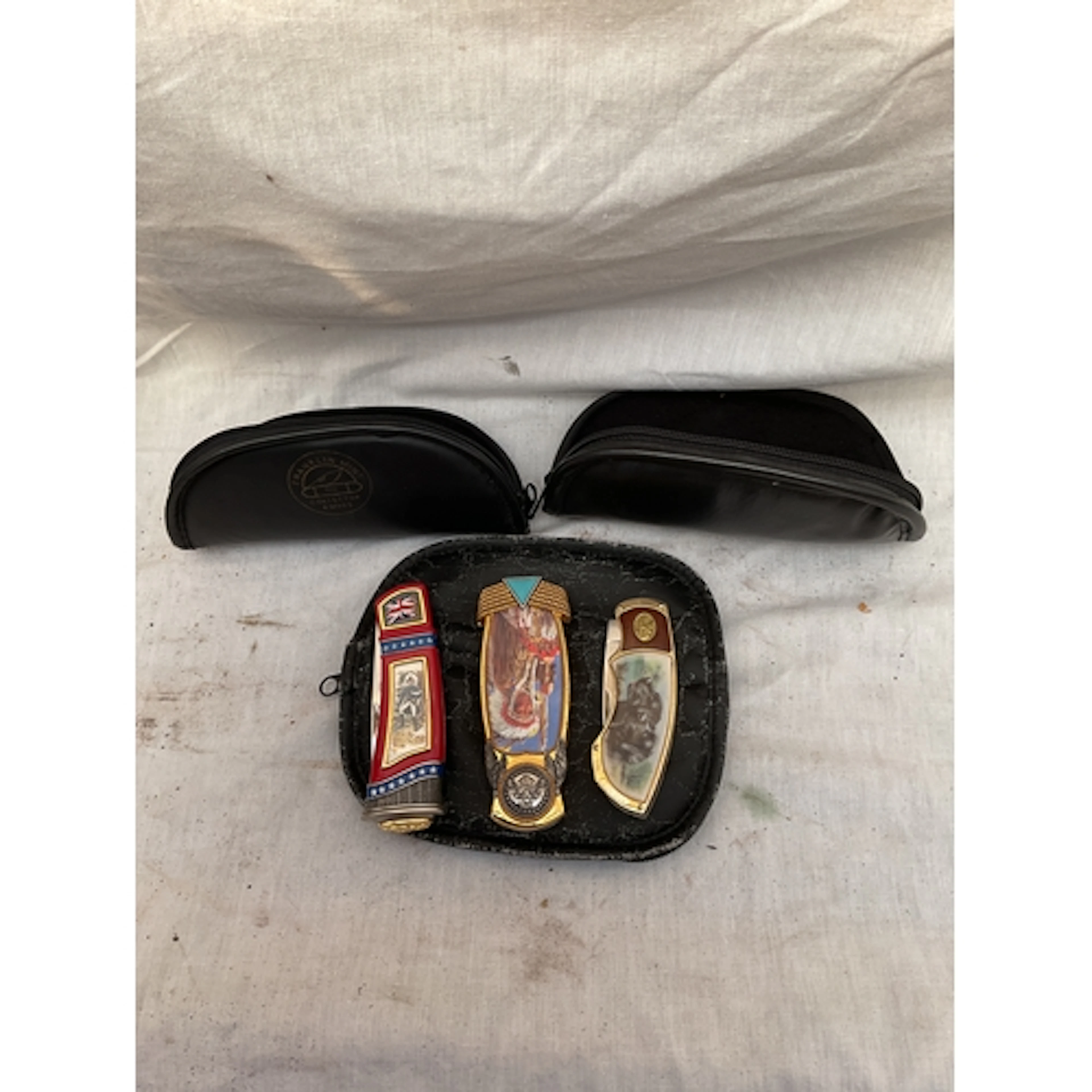 Three Franklin Mint ornate penknives and pouches.