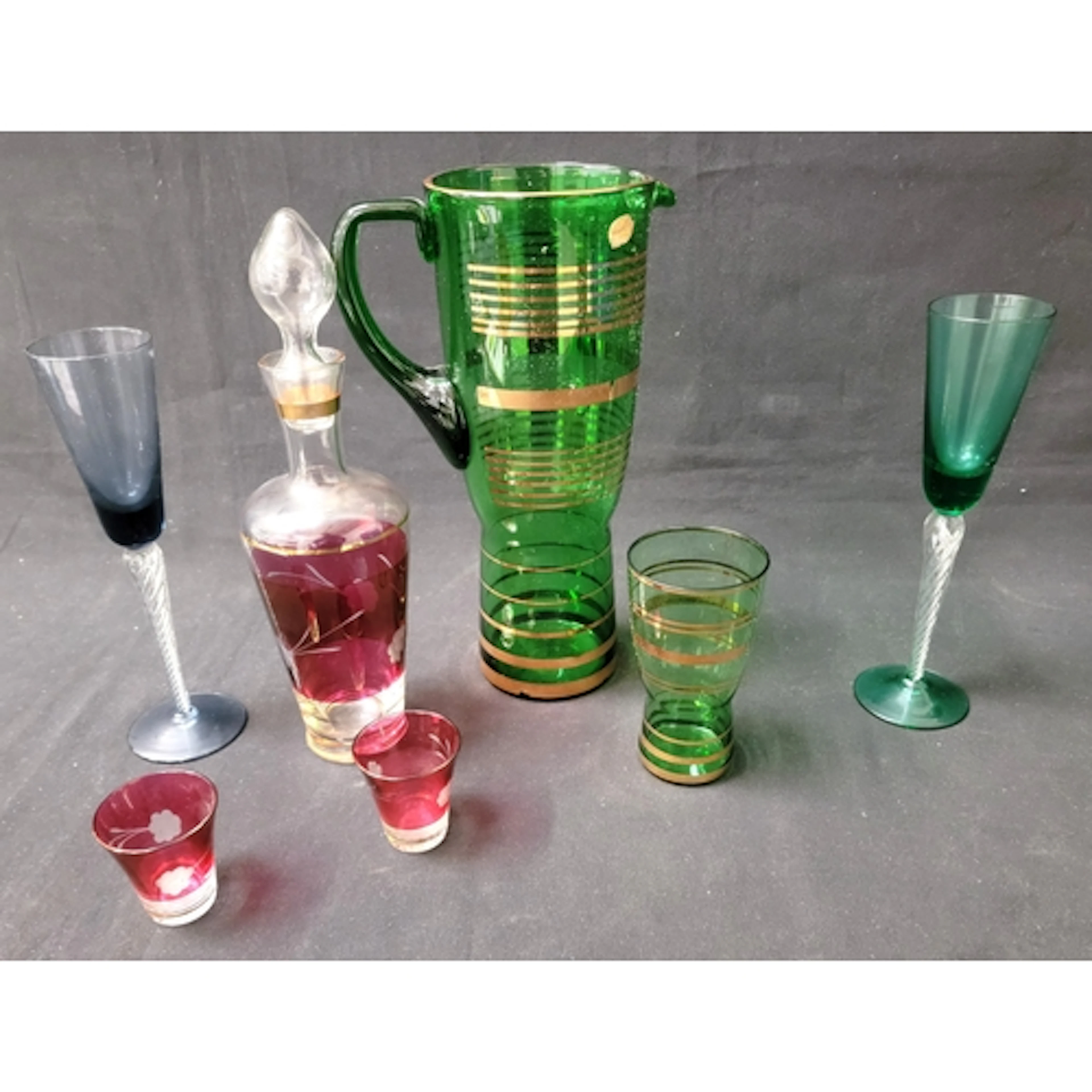 SELECTION OF COLOURED GLASSWARE including nine flutes with ...