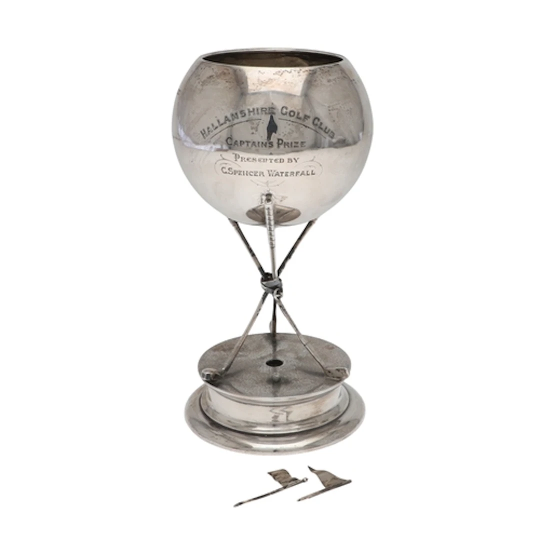 A SILVER GOLFING TROPHY CUP. The spherical top with engraved...