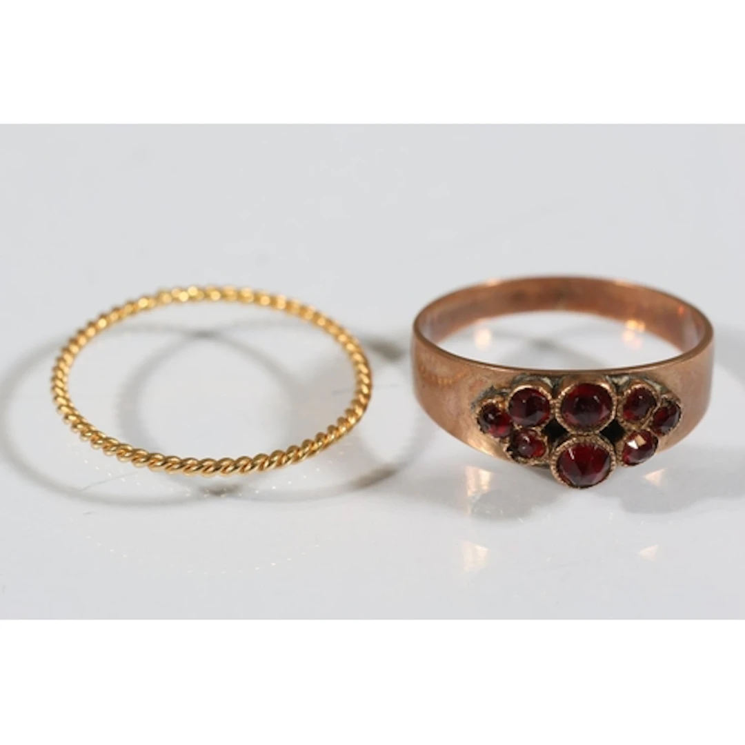Rose gold tone dress ring set with garnet red stones, size K...