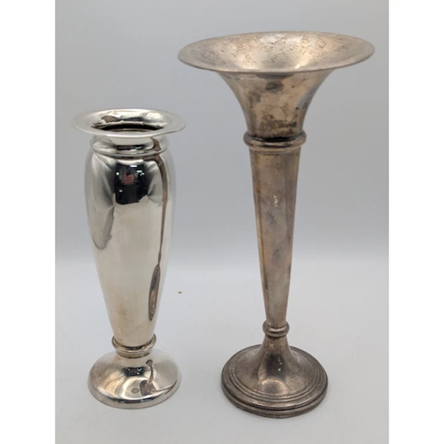 Two silver weighted vases, one with a shallow neck and flare...