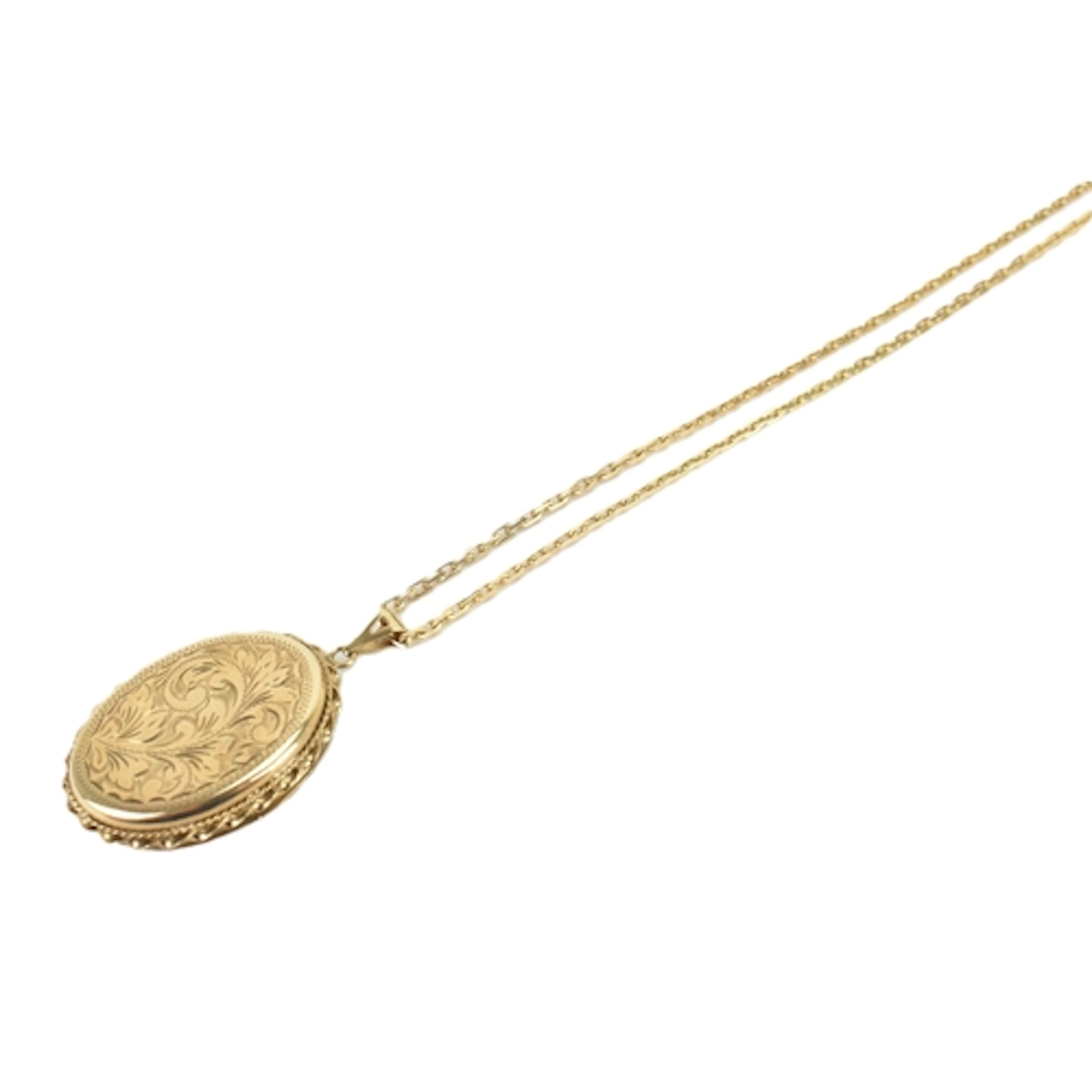A 9ct yellow gold locket and chain, the locket engraved with...