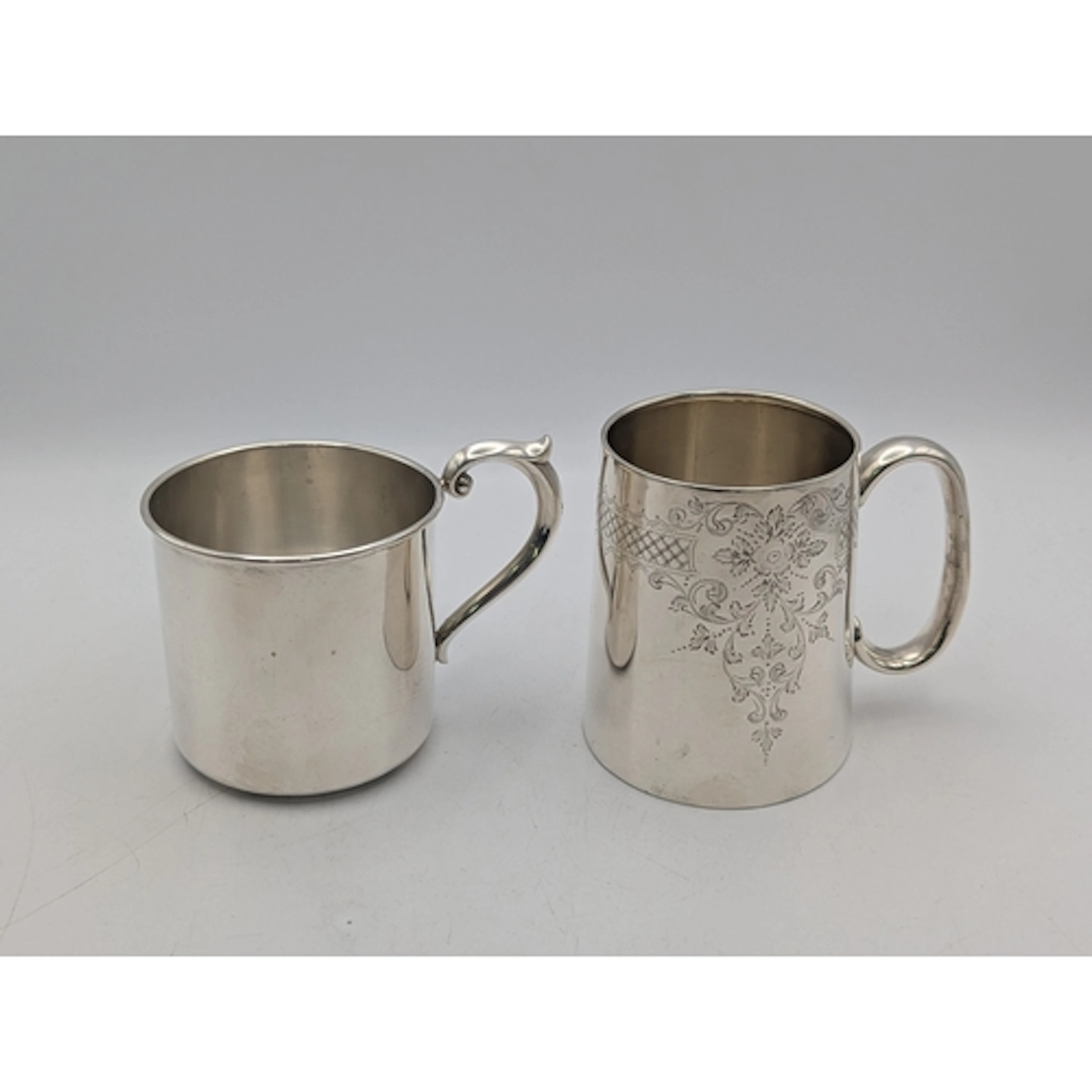 Two silver mugs to include a George V silver example with fl...
