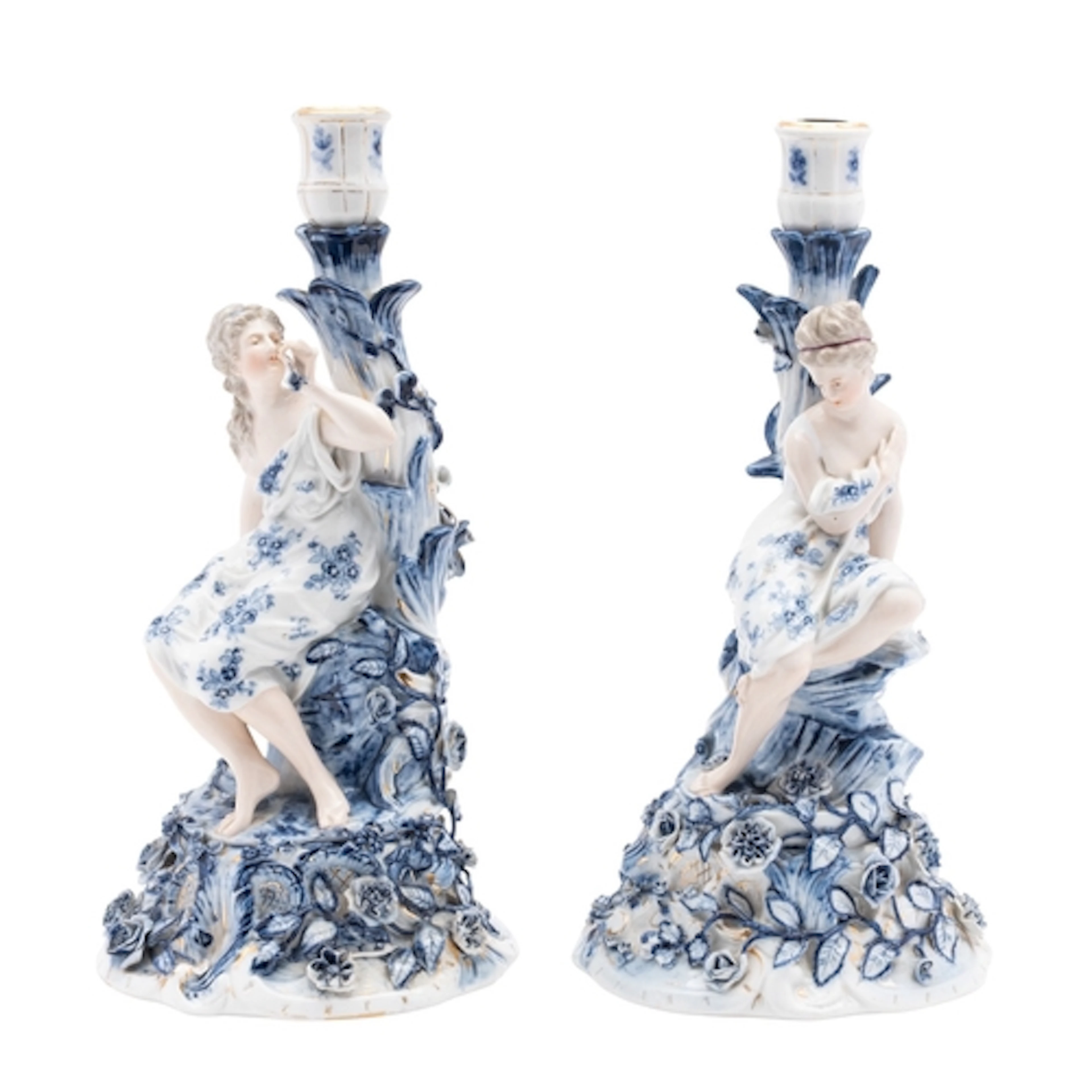 A pair of German porcelain figural candlesticks each with a ...