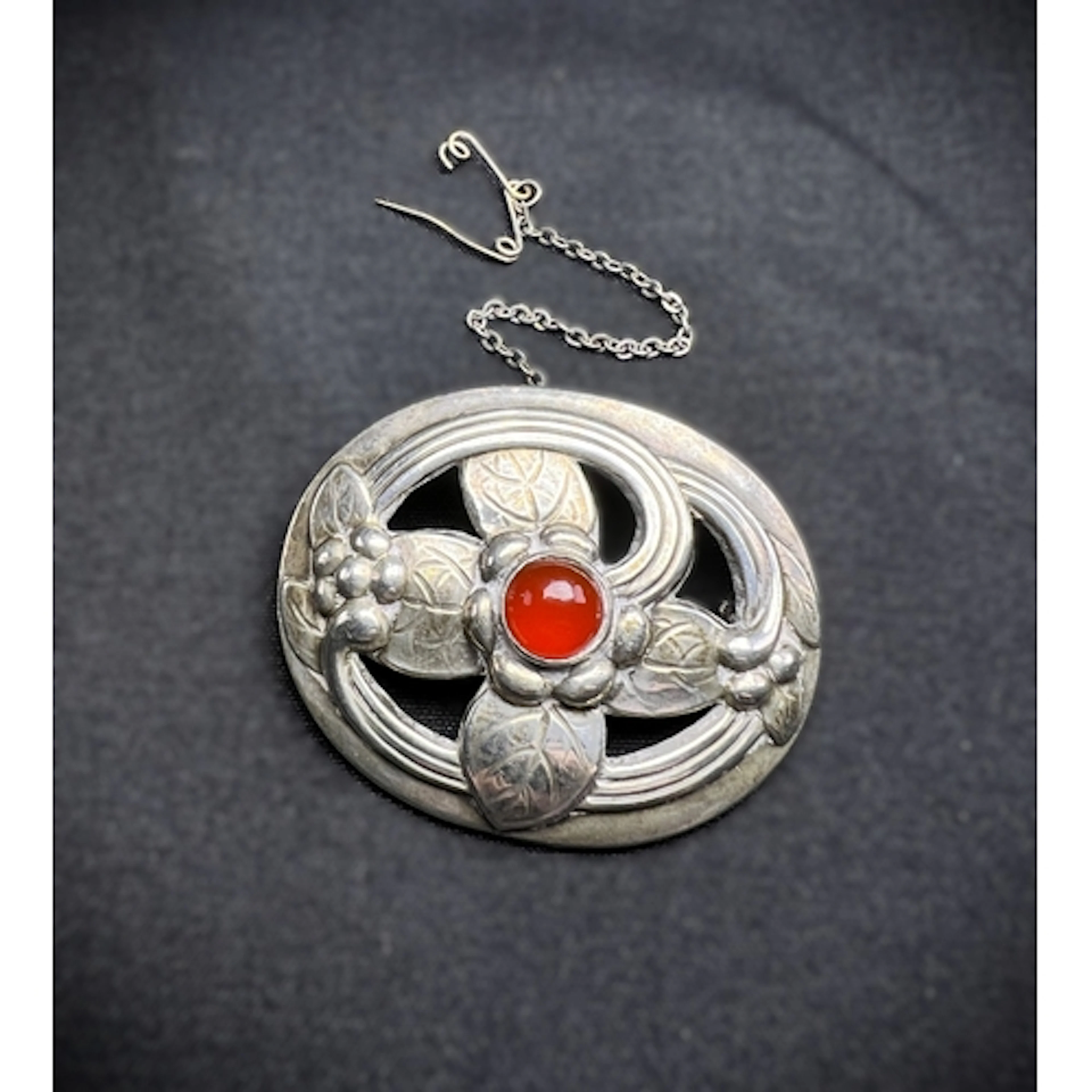 GEORG JENSEN: an oval brooch in the form of a stylised flowe...