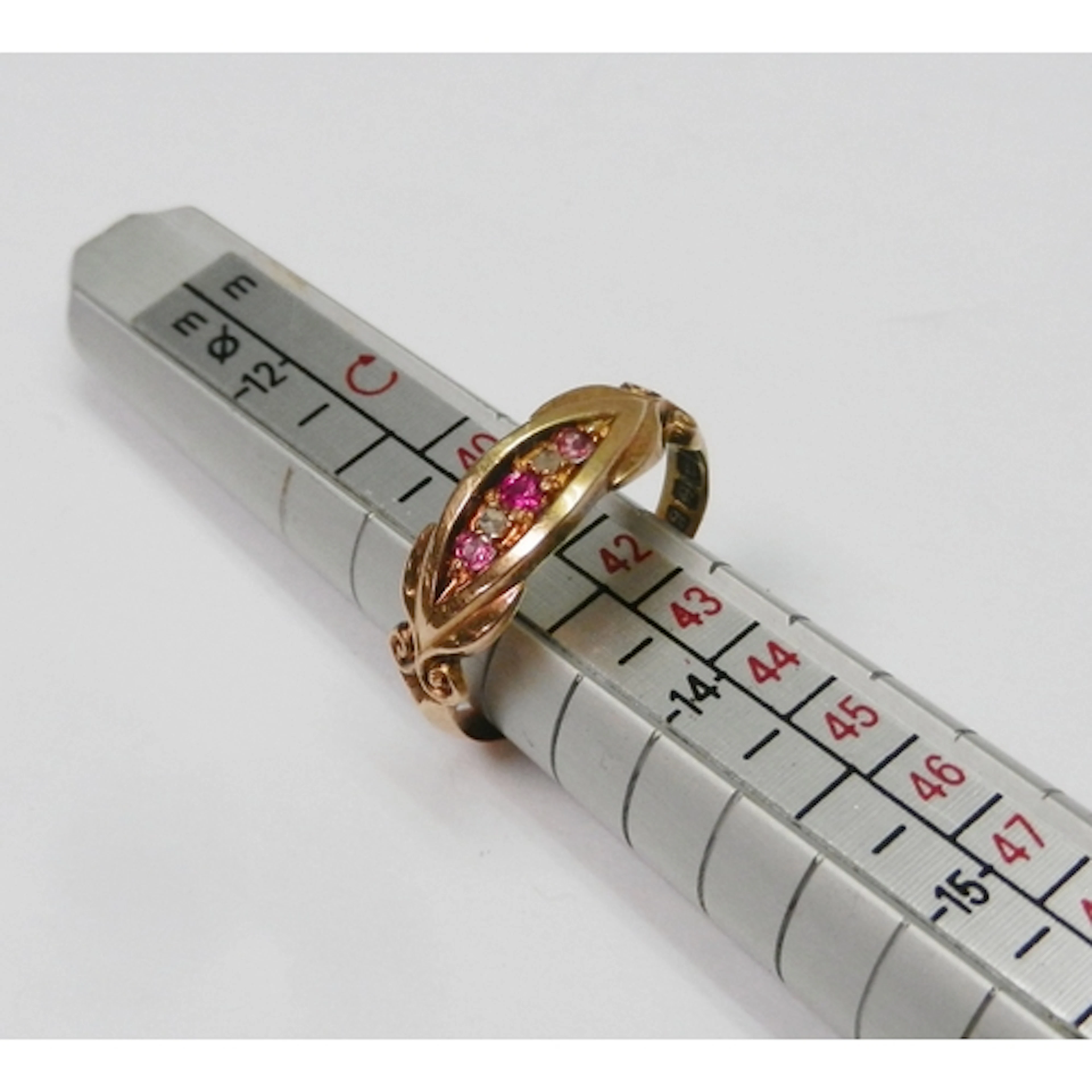 An Edwardian 18ct gold five stone ring channel set with two ...