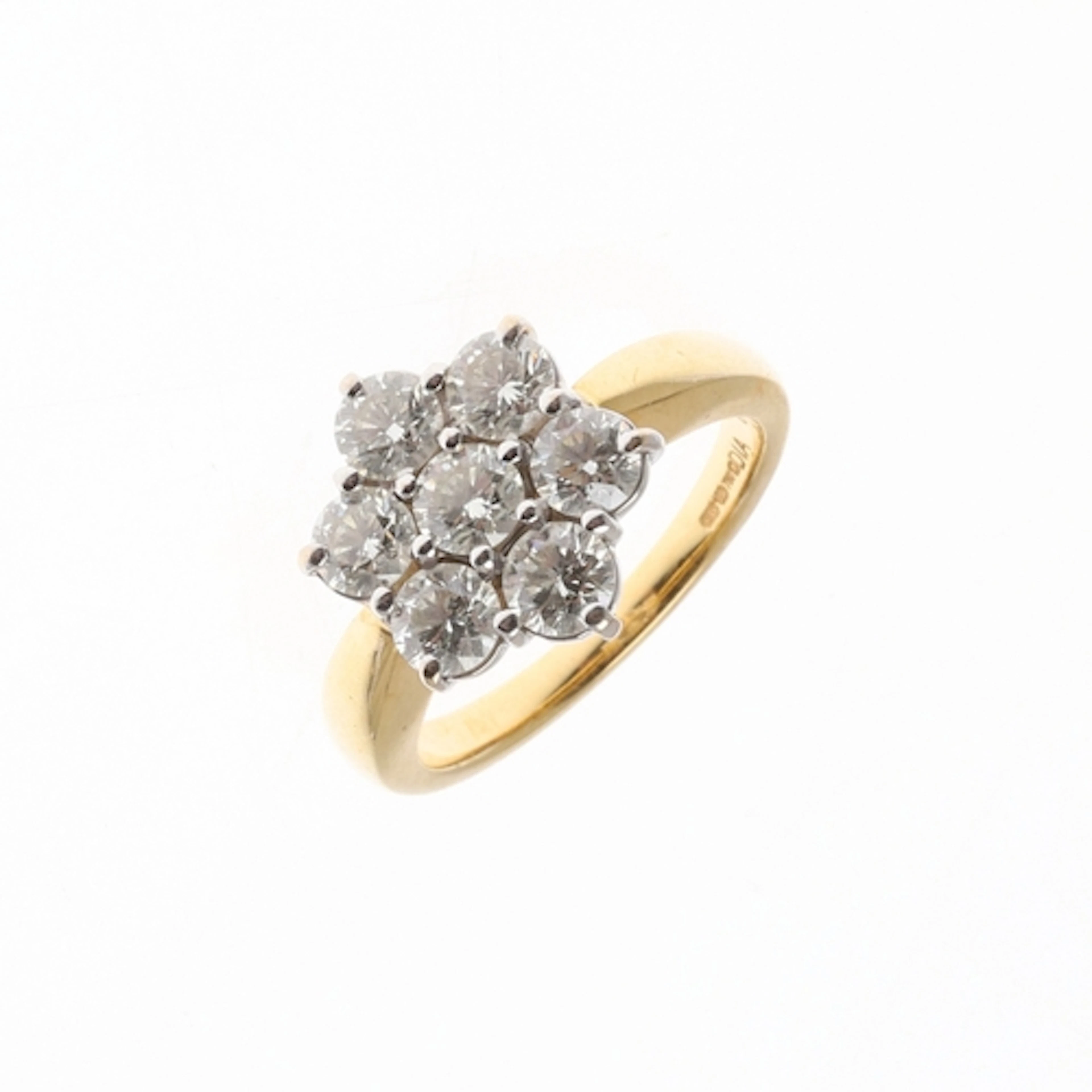 A DIAMOND CLUSTER RING. mounted with seven brilliant-cut dia...