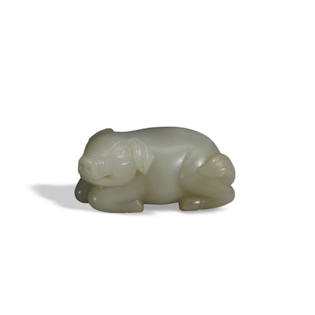 A FINE WHITE JADE CARVING OF A PIG QING DYNASTY, 19TH CENTUR...