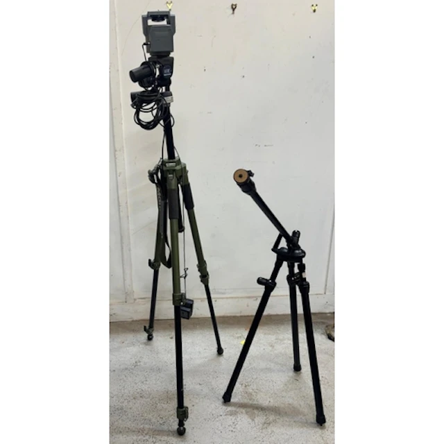 A Manfrotto heavy-duty tripod setup in green and black along...
