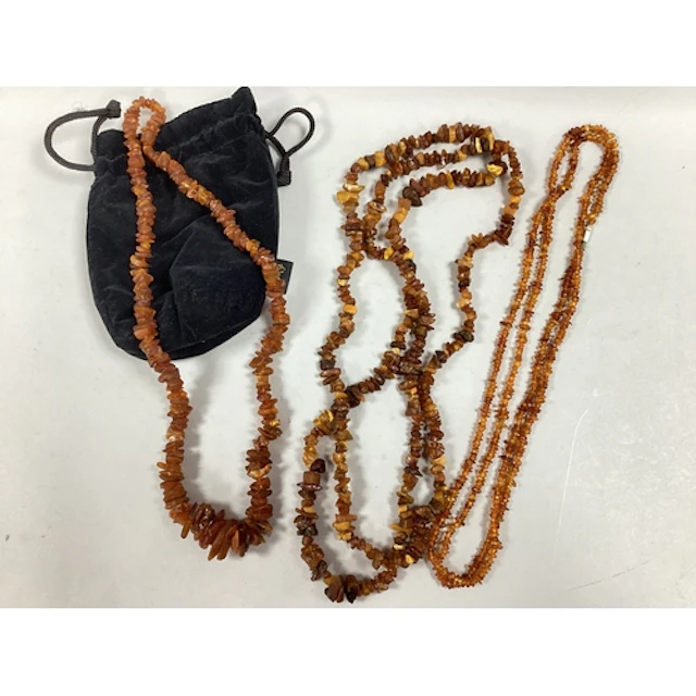 Three Amber Coloured Necklaces, including graduated raw bead...