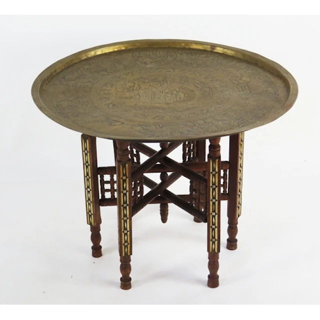 A middle eastern brass circular tiffin table with folding st...