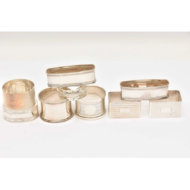 AN ASSORTMENT OF SILVER NAPKIN RINGS, to include two pairs o...