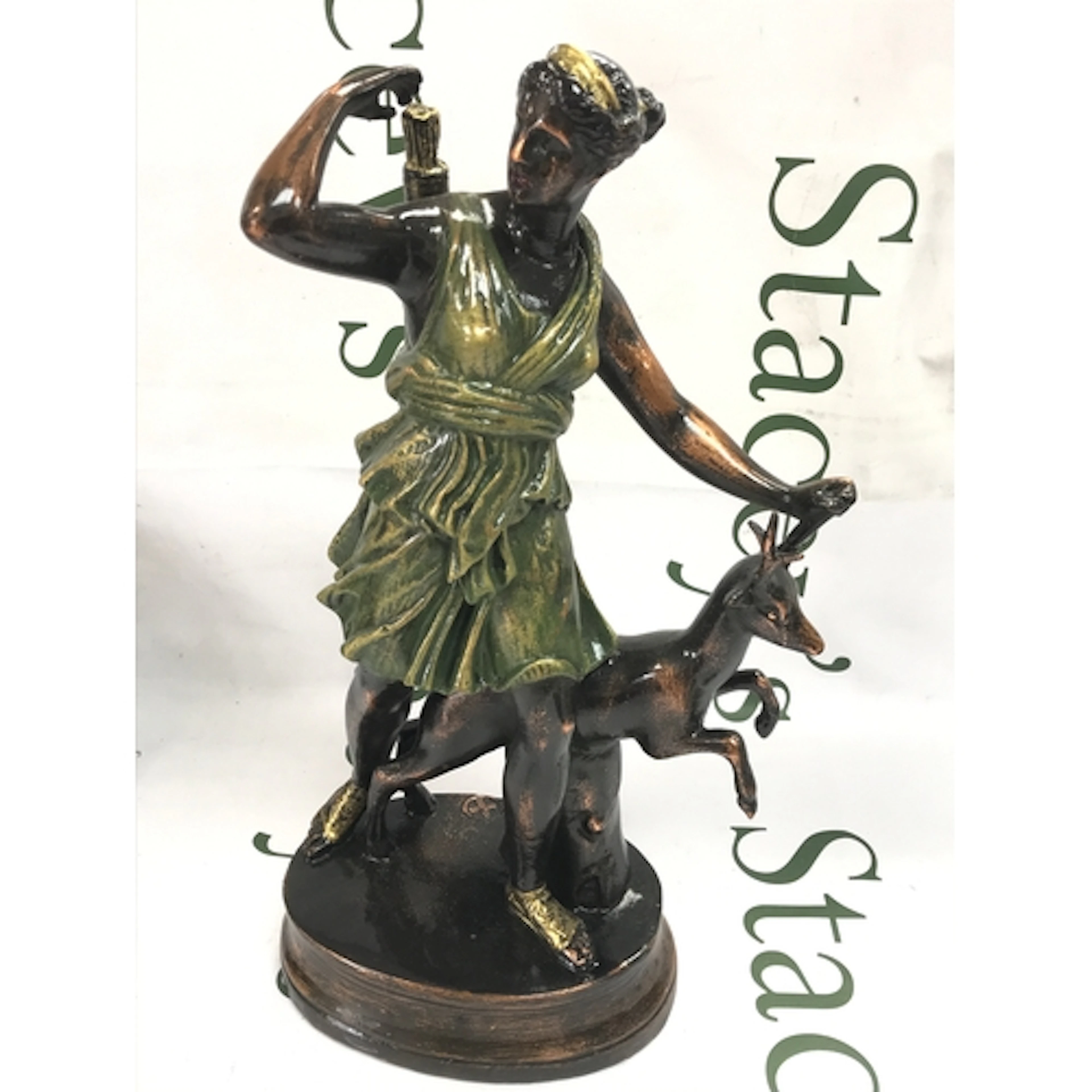 A metal cast figure of Diana the Huntress with a deer, model...