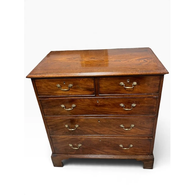 A GEORGIAN MAHOGANY CHEST OF DRAWERS Two short over three lo...