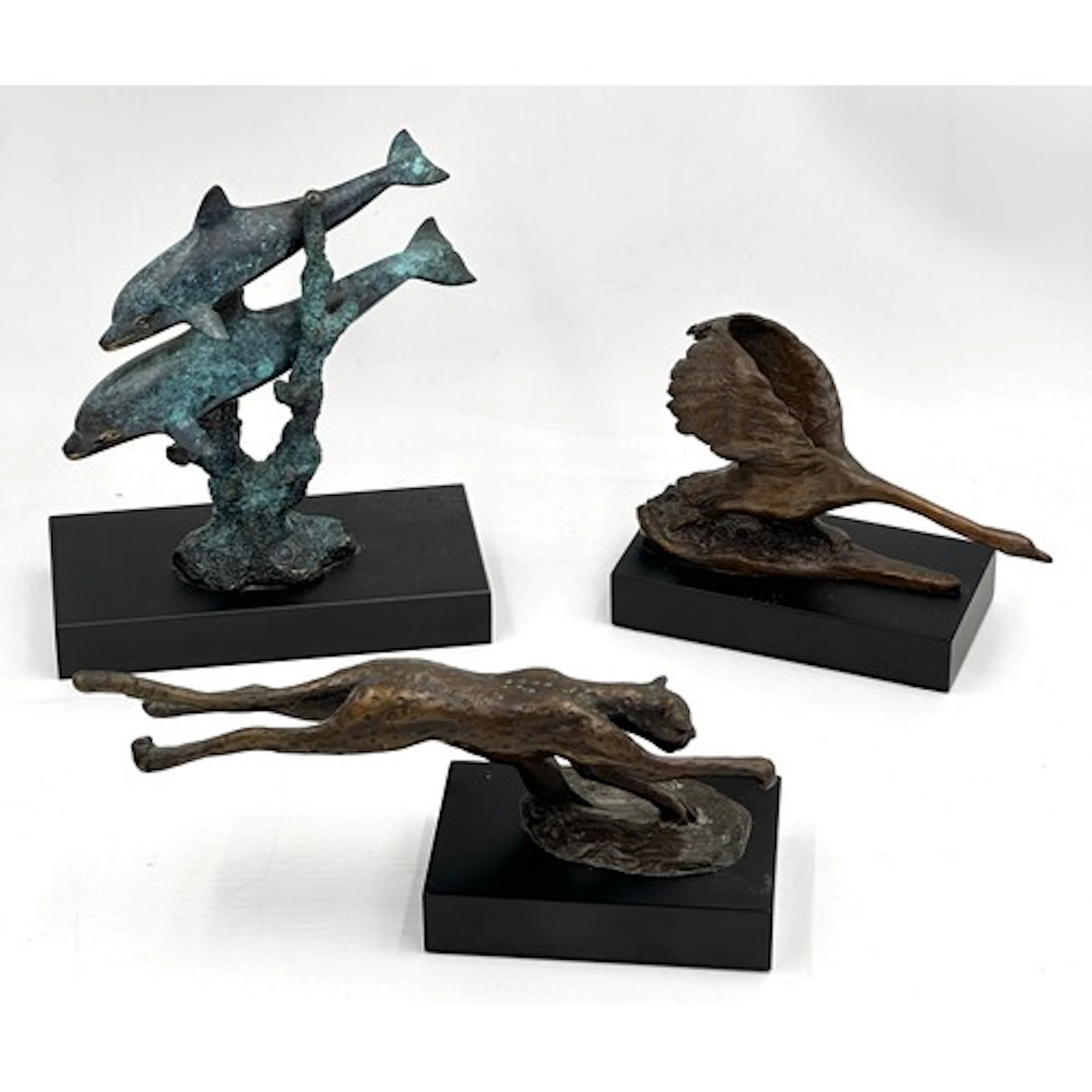 Three bronze figurines raised on plinths by the Bronzart Cas...