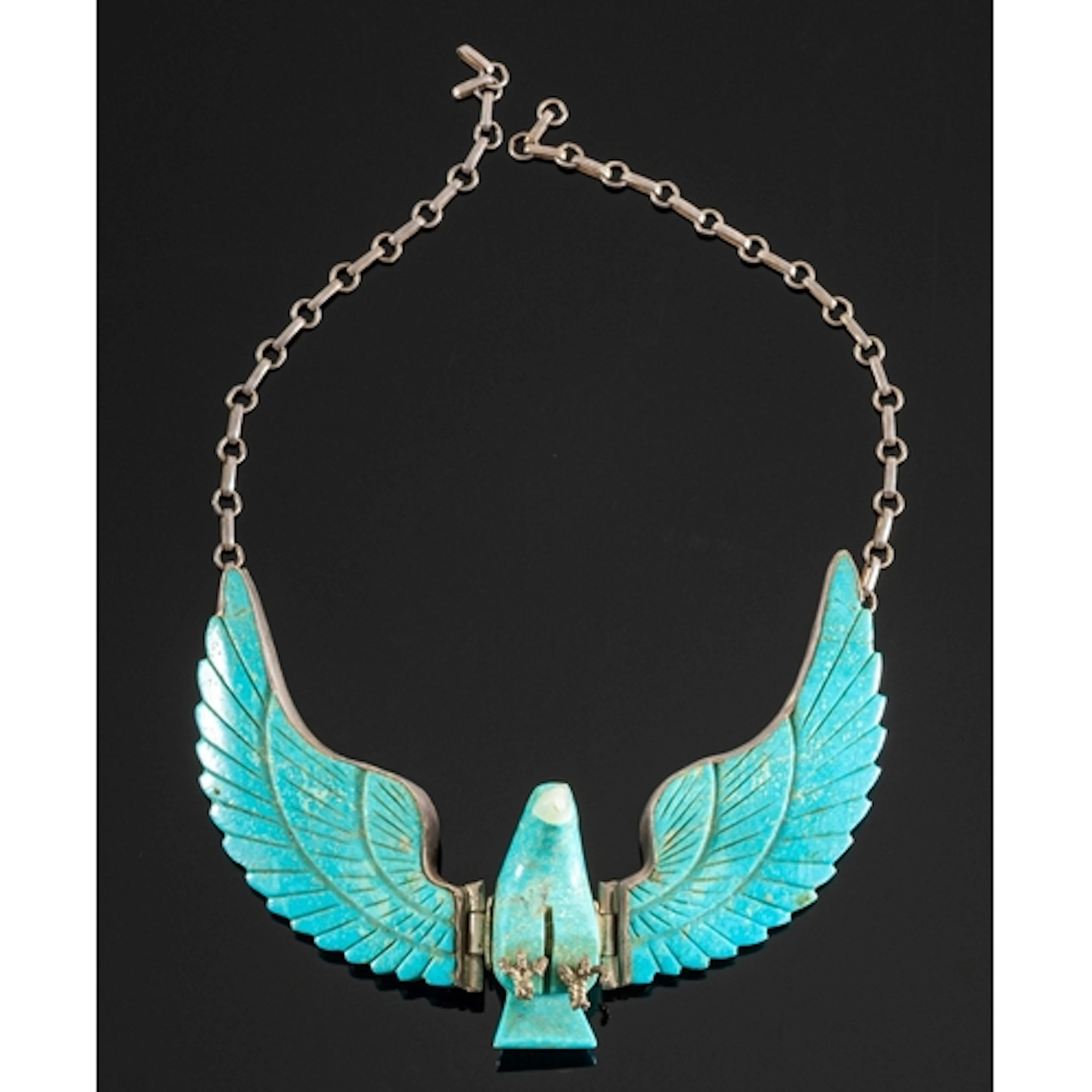 Harry Spencer, a Navajo artist, carved turquoise eagle neckl...