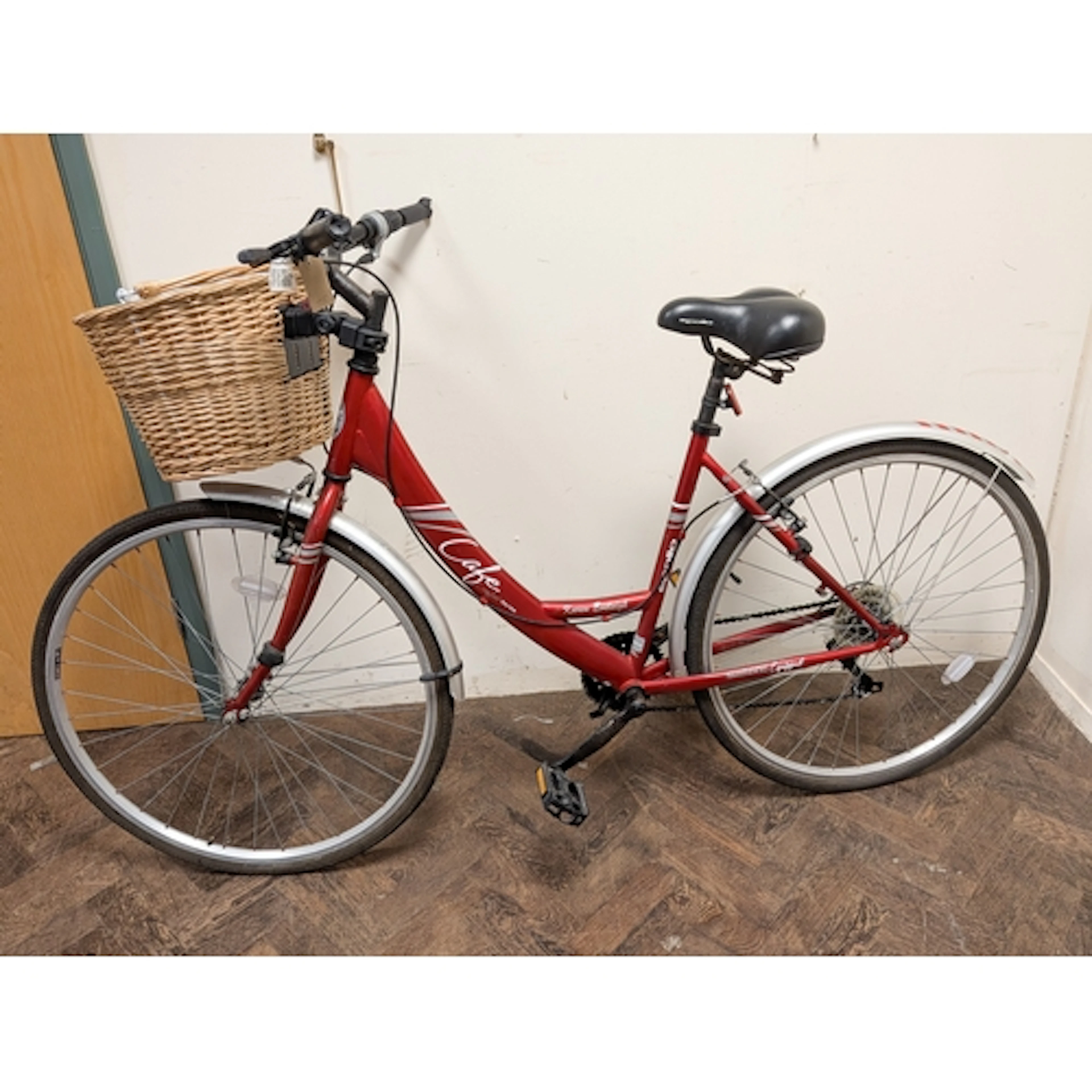A ladies red Apollo comfort series bicycle with front wicker...