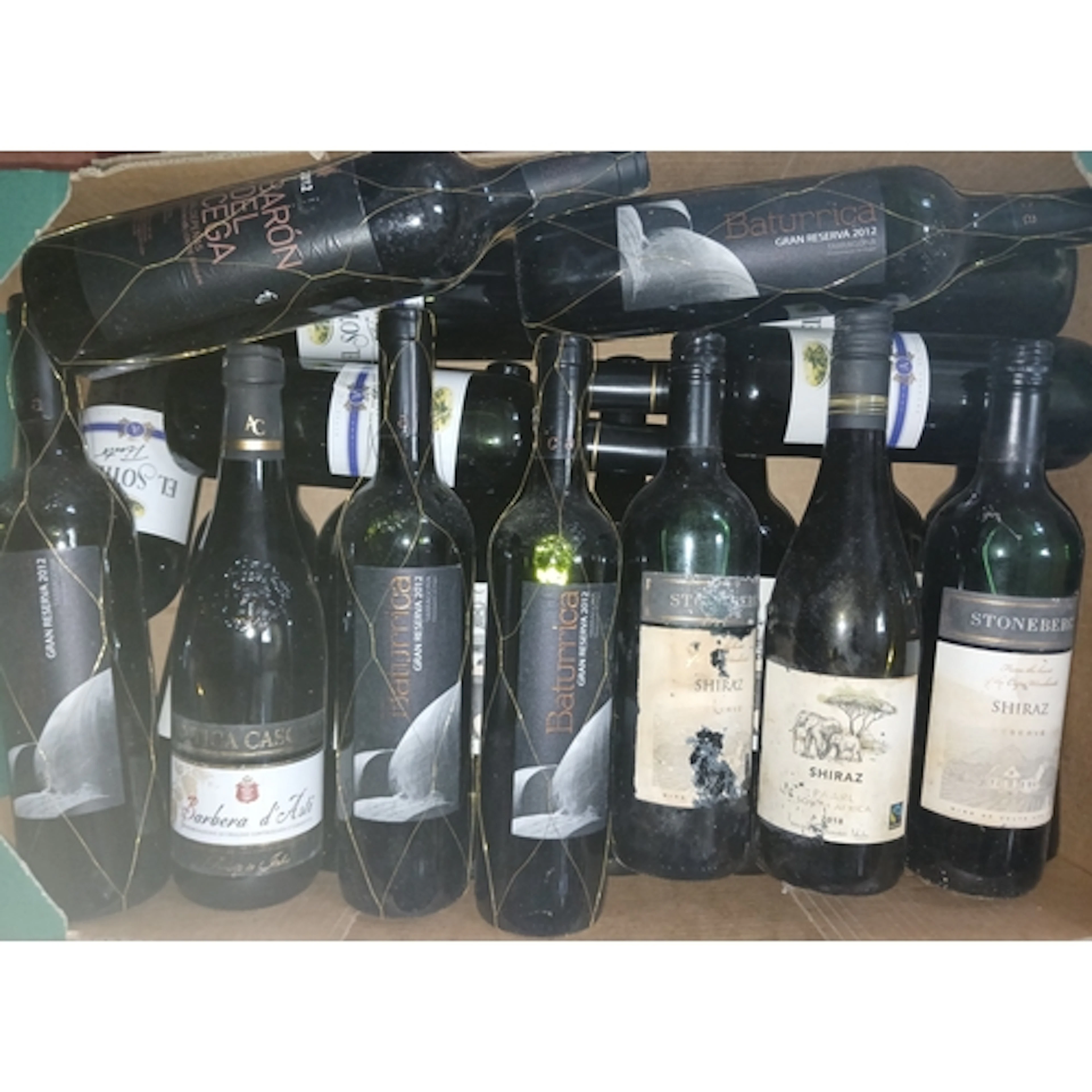 Four boxes of assorted red wines.