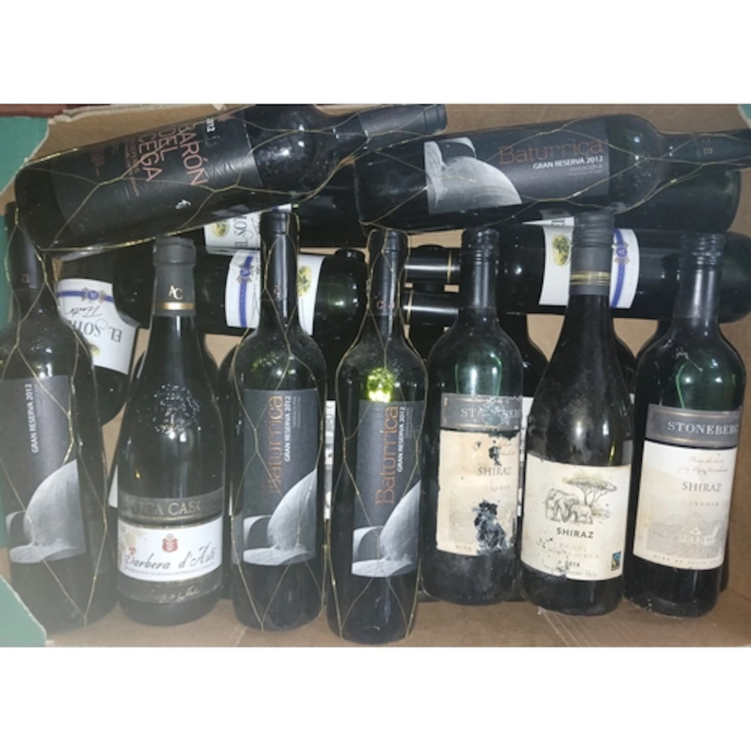 Four boxes of assorted red wines.