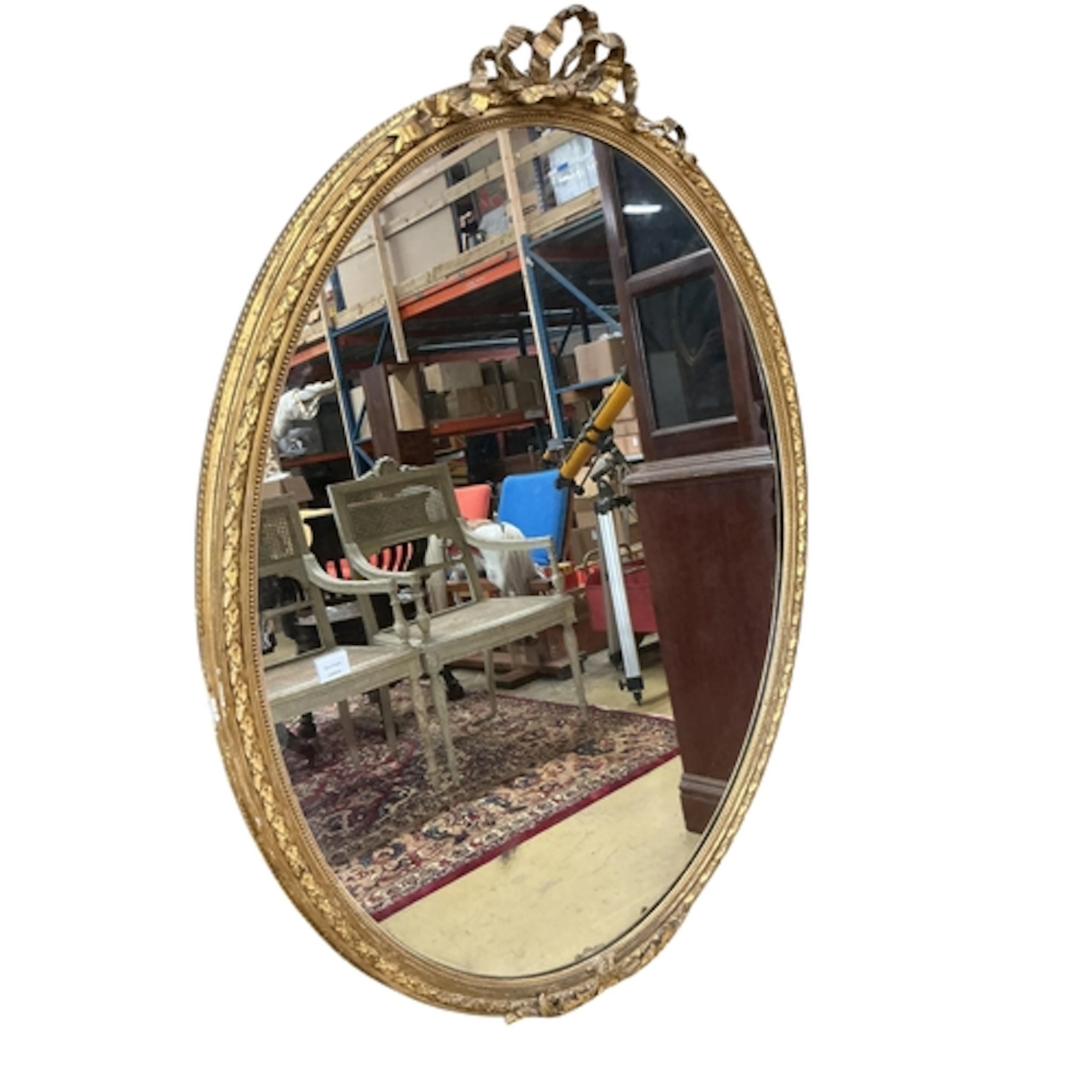 A large Victorian oval giltwood and composition wall mirror,...