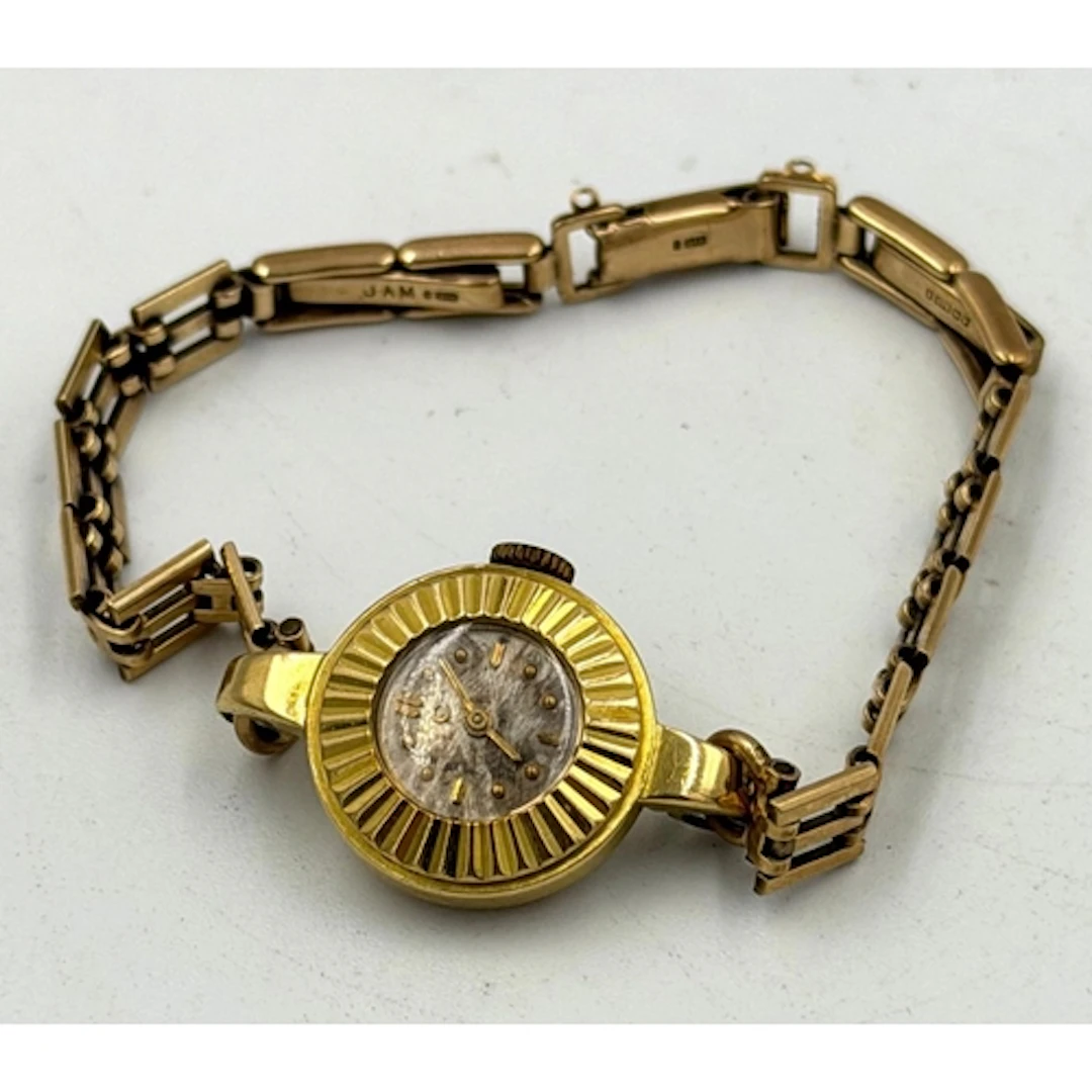 An 18ct ladies watch on a 9ct gold bracelet with a combined ...
