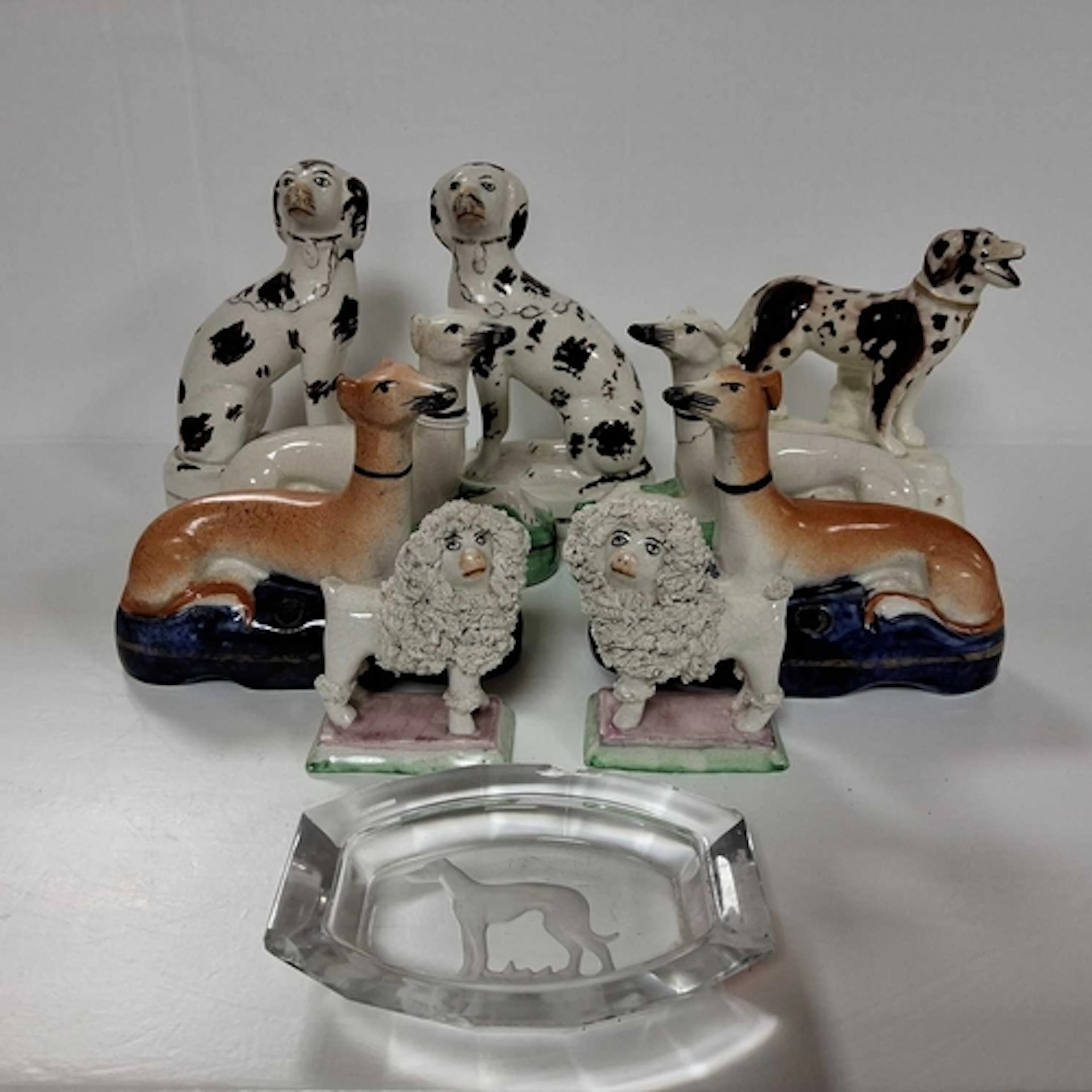 A GROUP OF STAFFORDSHIRE DOGS ETC comprising a mirrored pair...