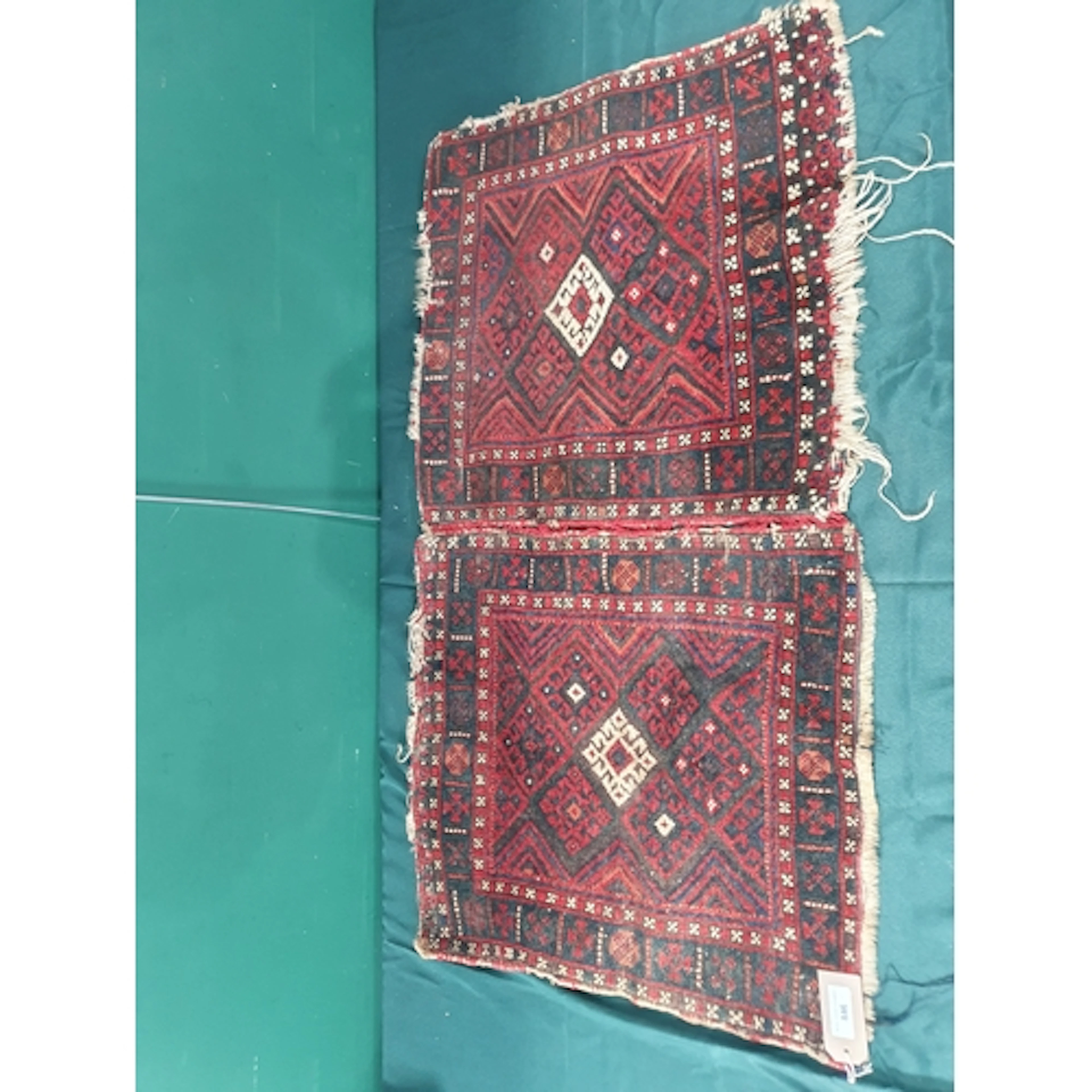 A Persian Saddle Bag with design of interlocking lozenges on...