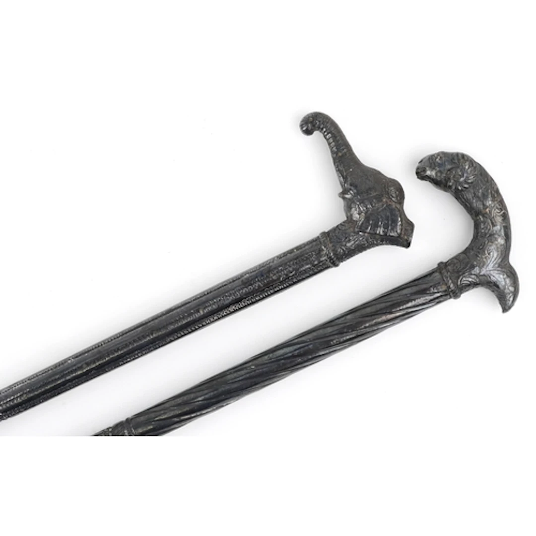 Two vintage Middle Eastern walking sticks with white metal o...