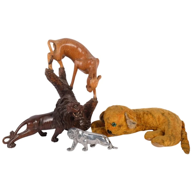 A carved hardwood lion, a carved hardwood sculpture of a che...