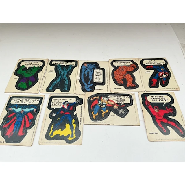 A Collection Of 9 1975 Topps Marvel Comic Book Hero Stickers