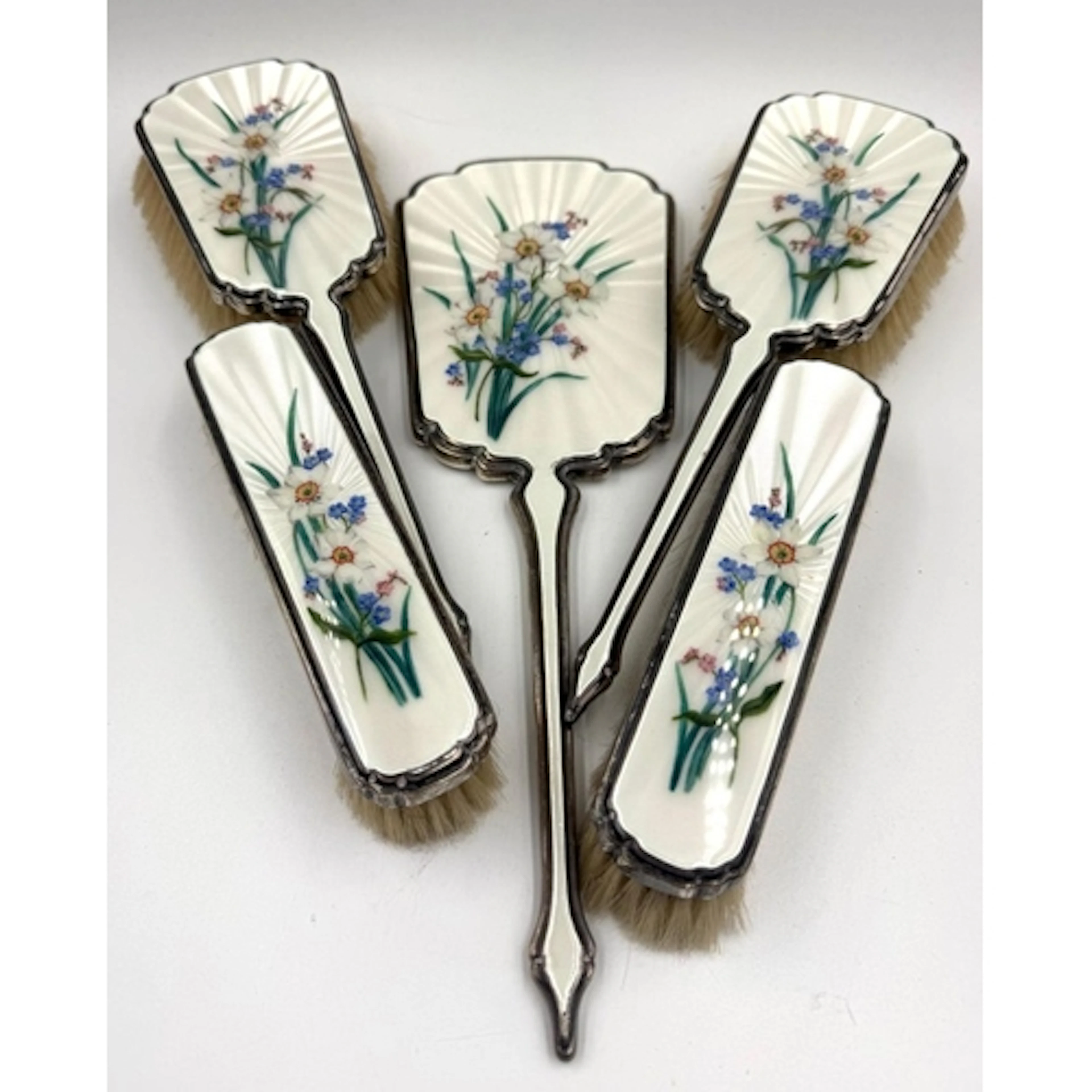 A selection of five silver vanity brushes and mirrors with f...