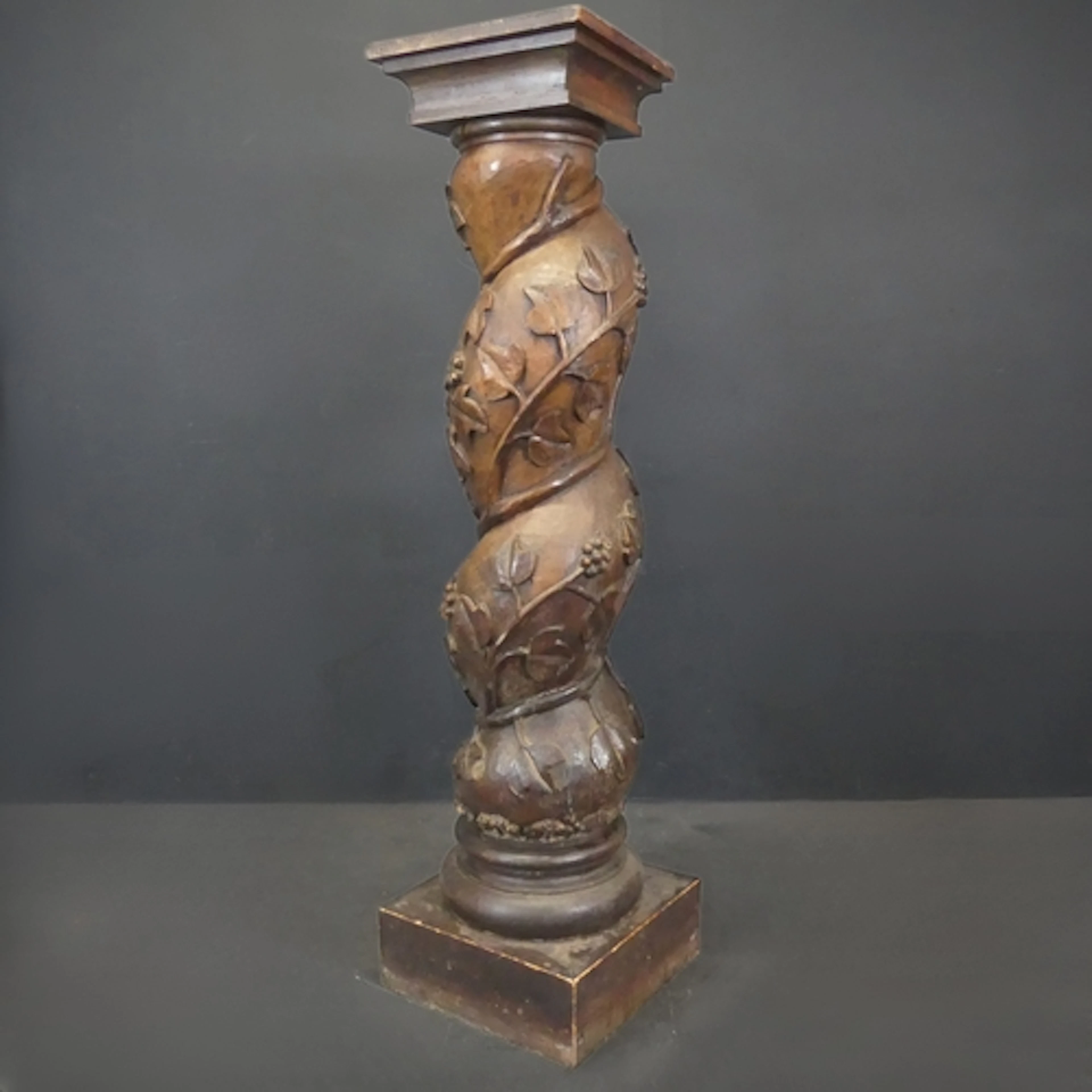 An antique French pressoir column plant stand, delicately ha...