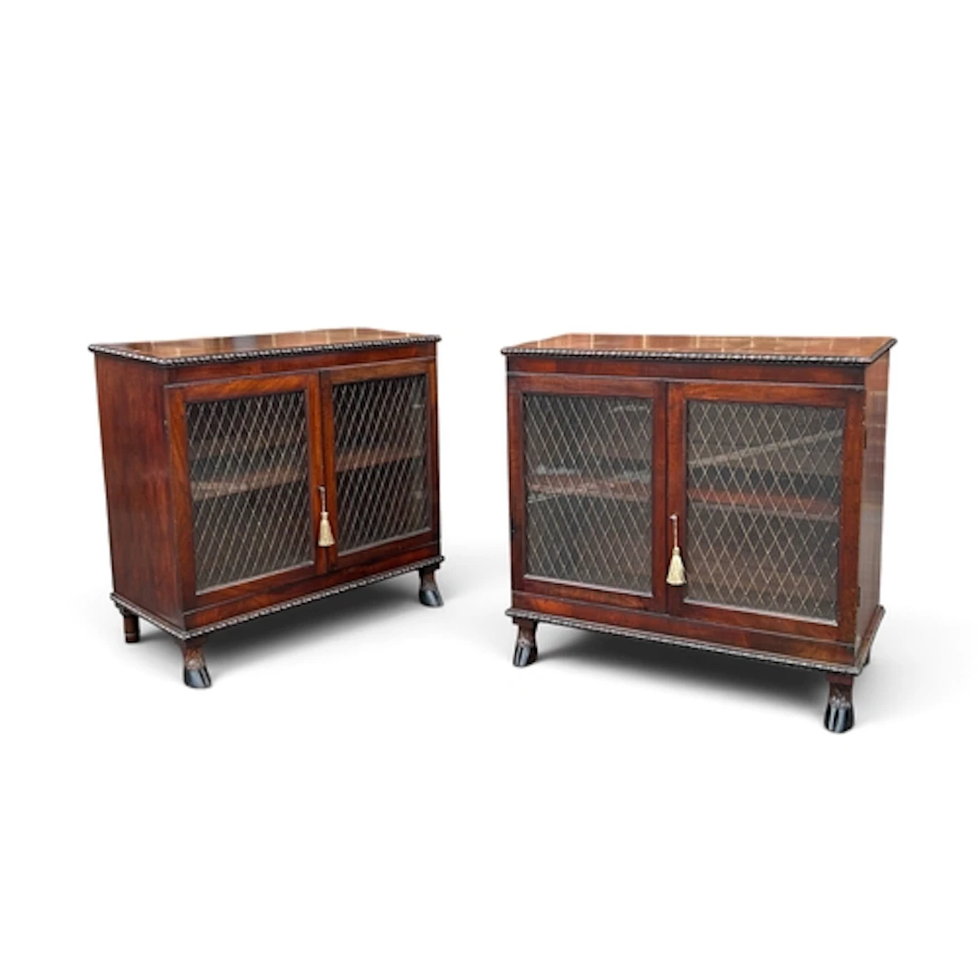 A PAIR OF REGENCY MAHOGANY CABINETS With brass wire mesh pan...
