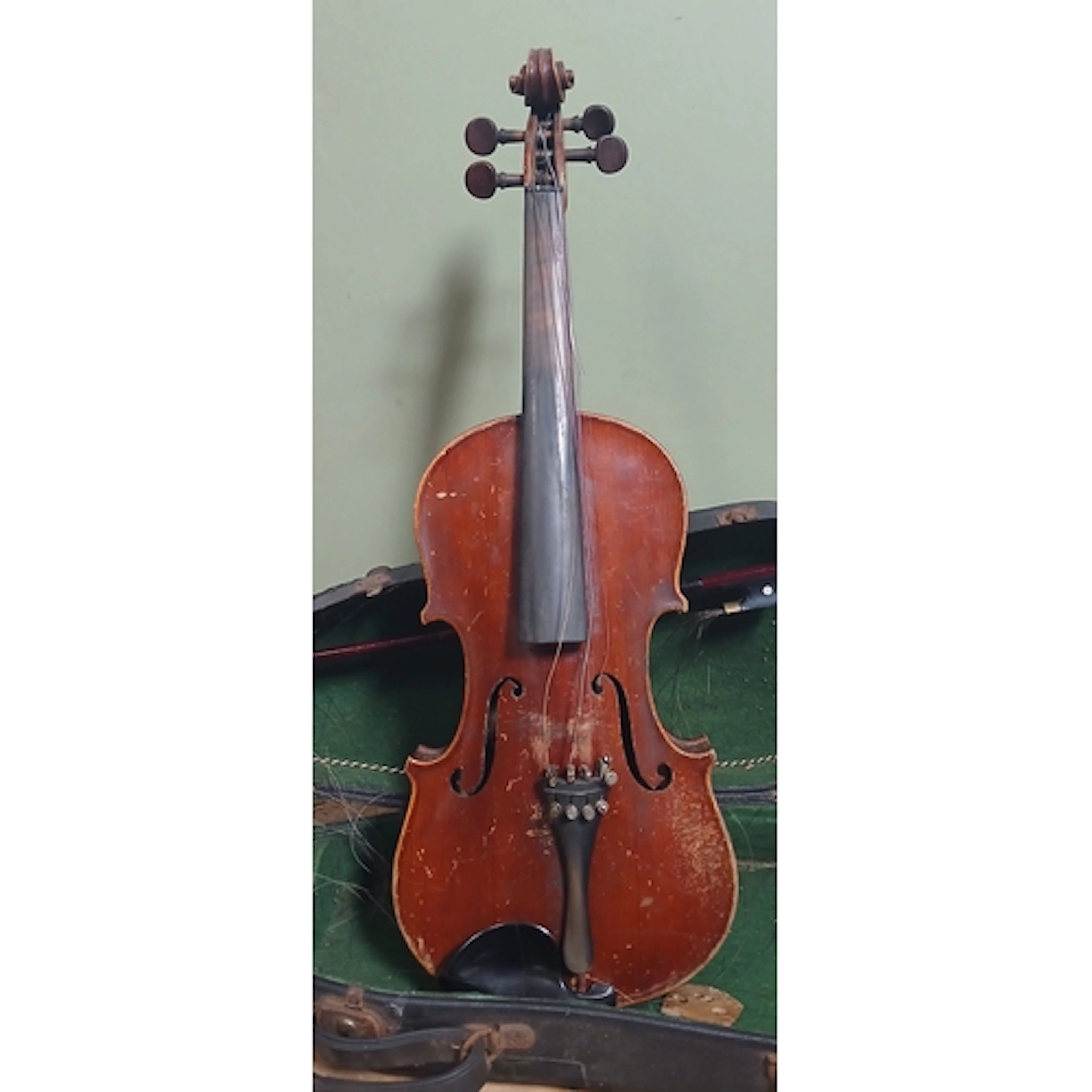 A violin labelled Antonio Martello with hard case and bow.