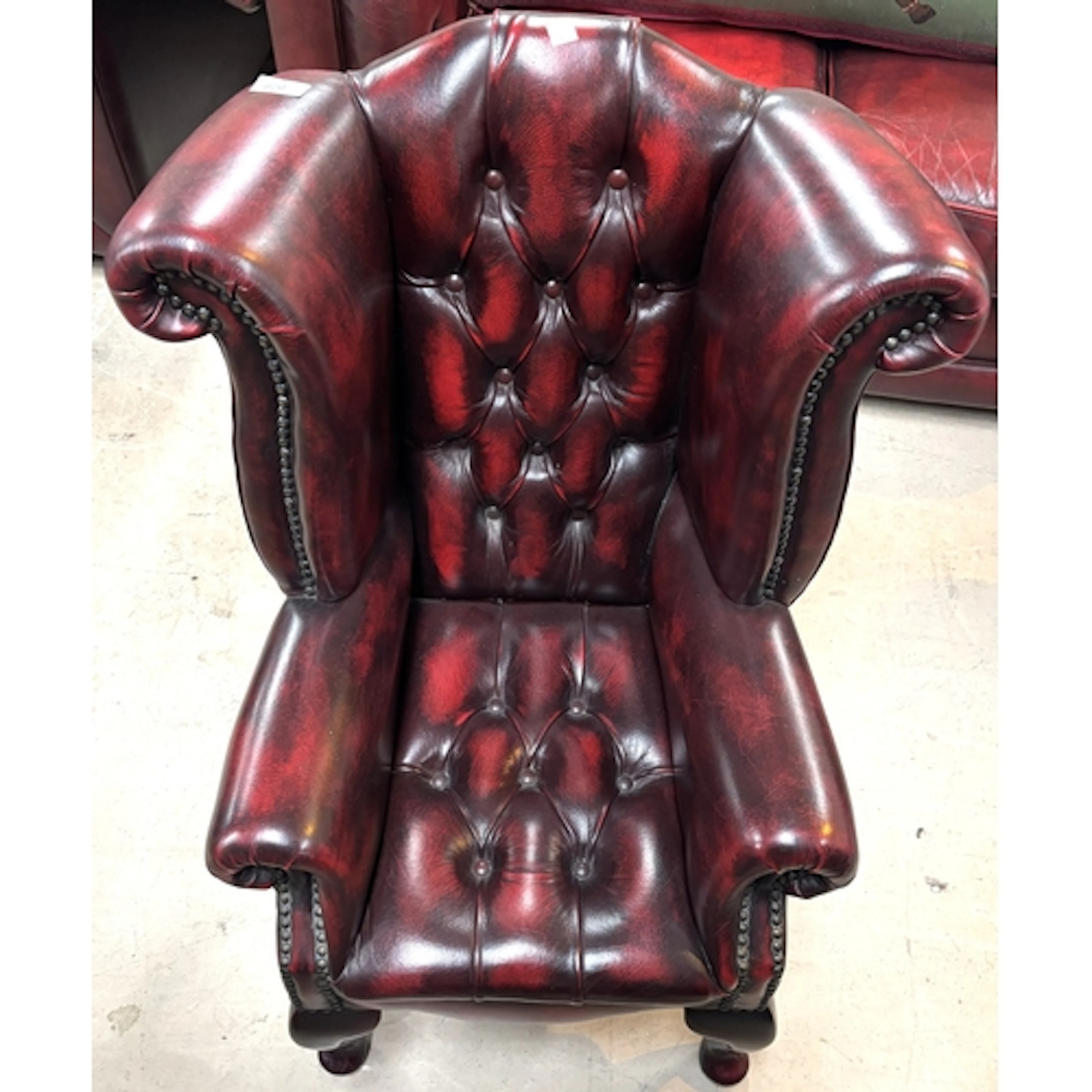 A deeply buttoned Chesterfield wing back child's chair in "a...
