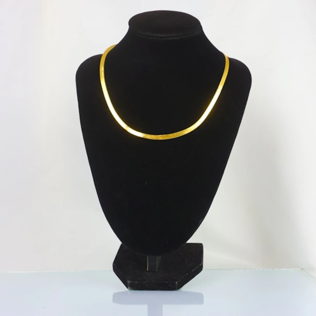 A contemporary Italian 9ct gold necklace, the flat snake lin...