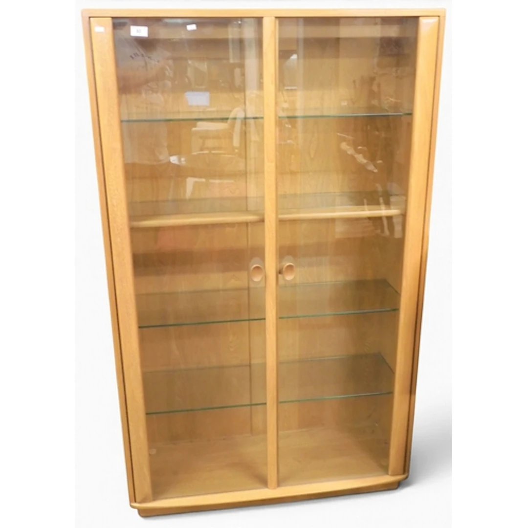 A 20th century Ercol elm and beech display cabinet with pair...