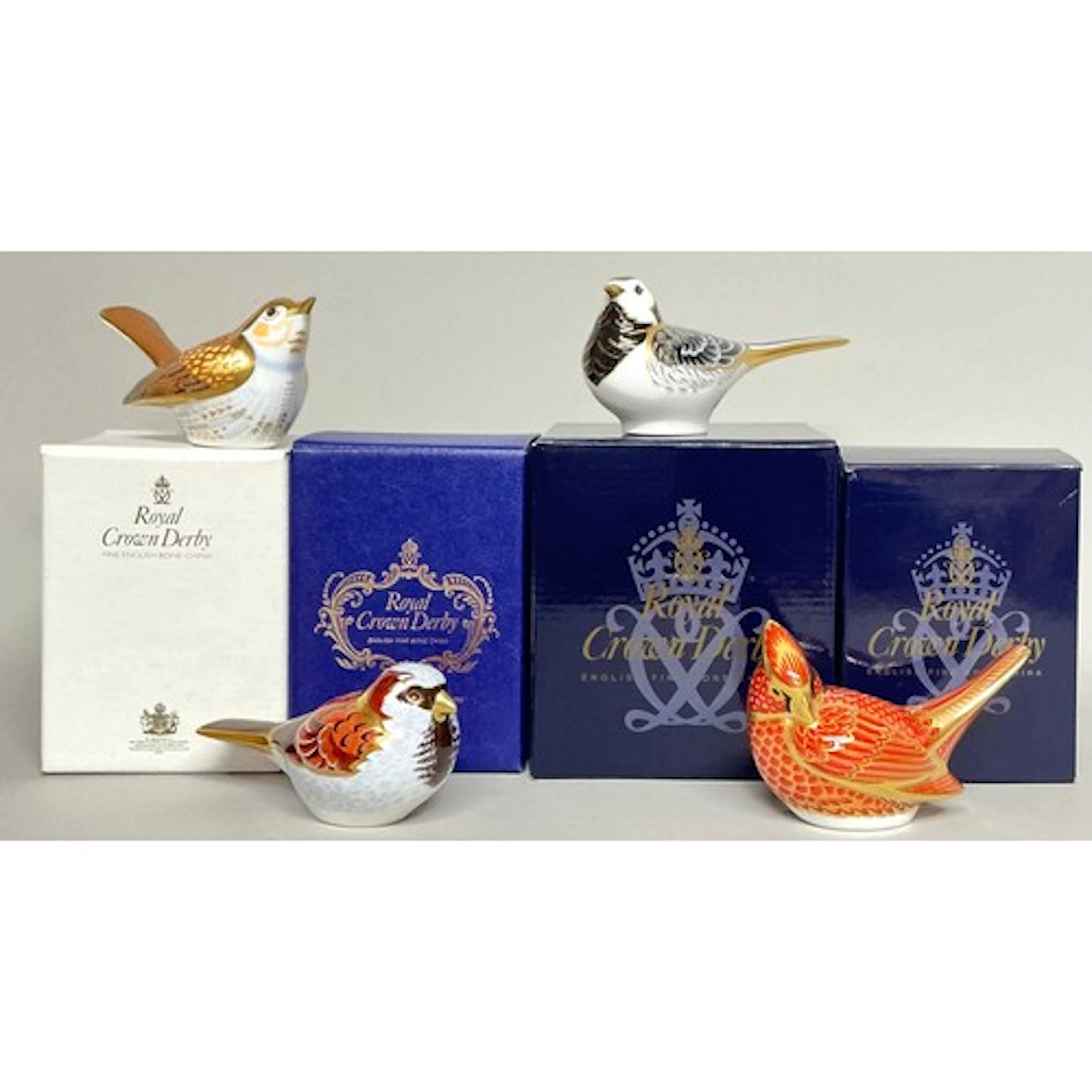 A Royal Crown Derby paperweight, House Sparrow, silver stopp...