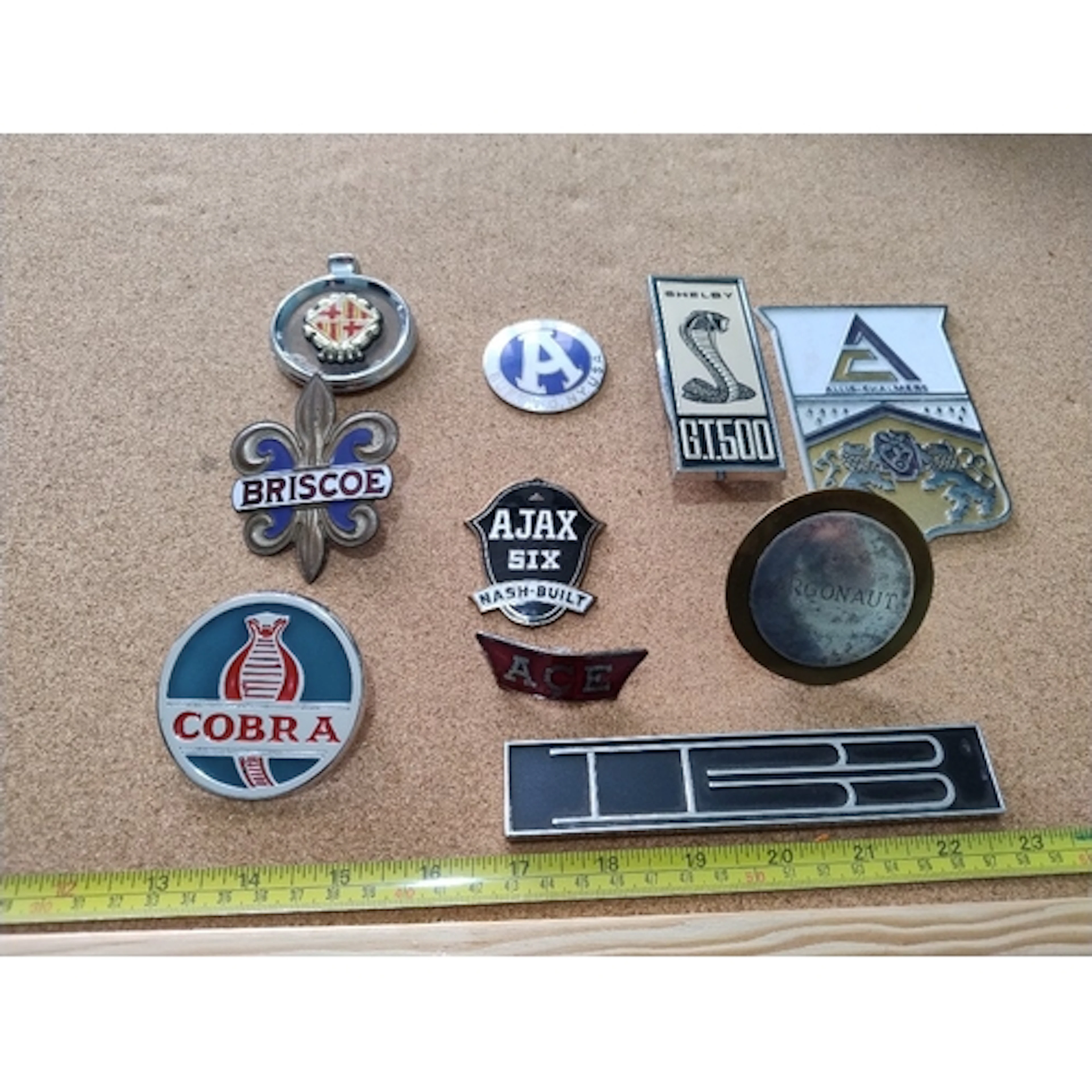 10 various car USA car badges including Cobra, ACE, Ajax, Br...