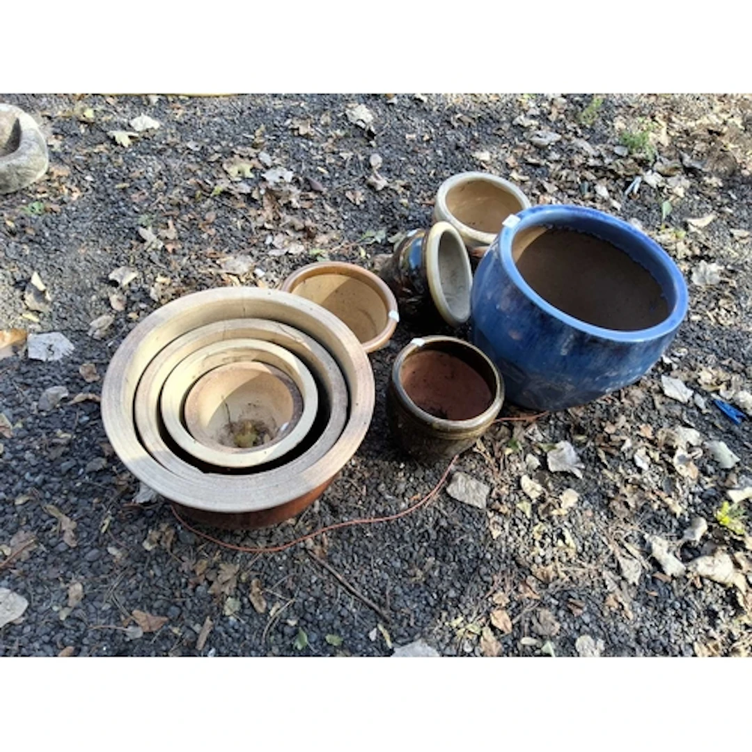 NINE GLAZED PLANT POTS including a graduated set of four bro...