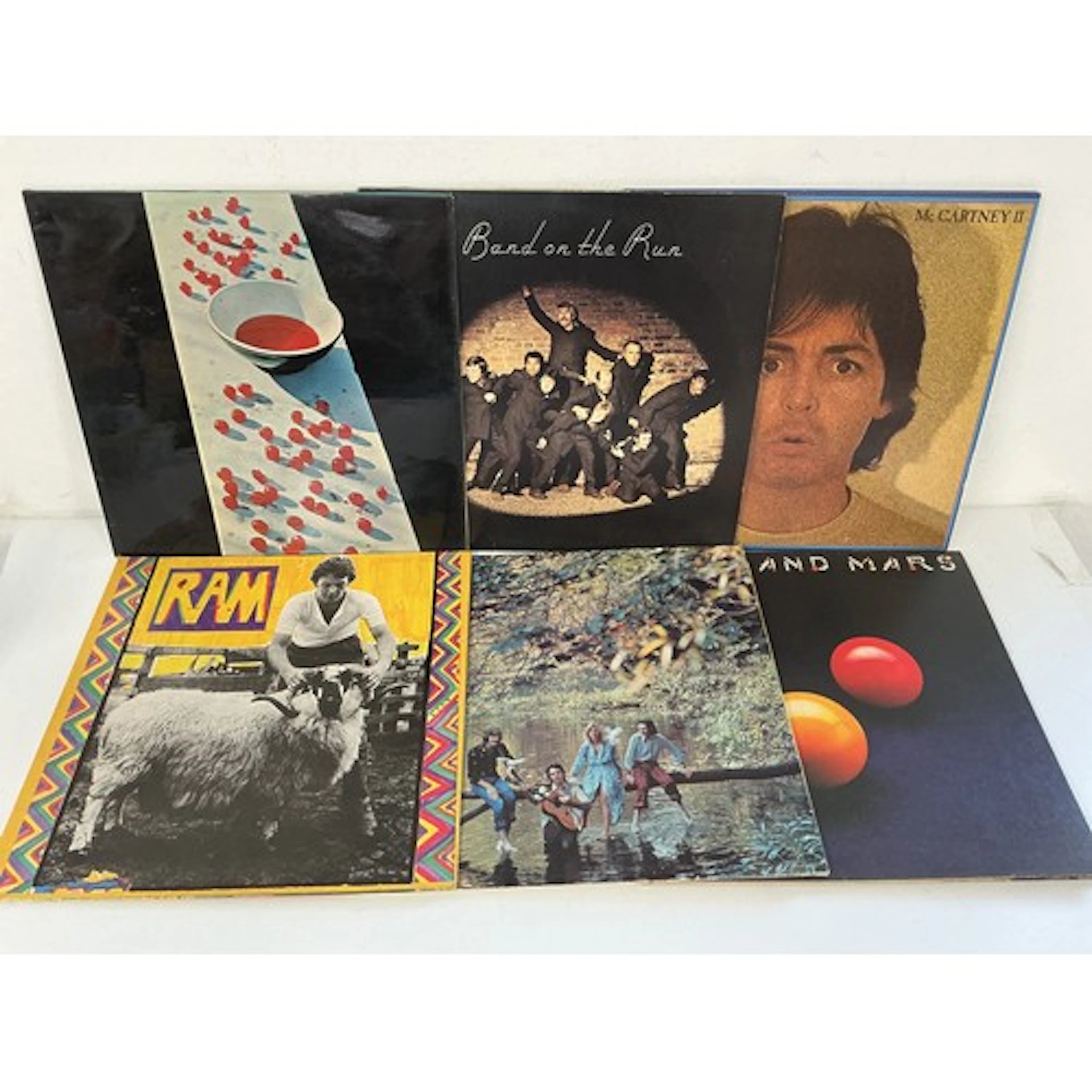 Two bags containing thirteen Paul McCartney and Wings LPs co...