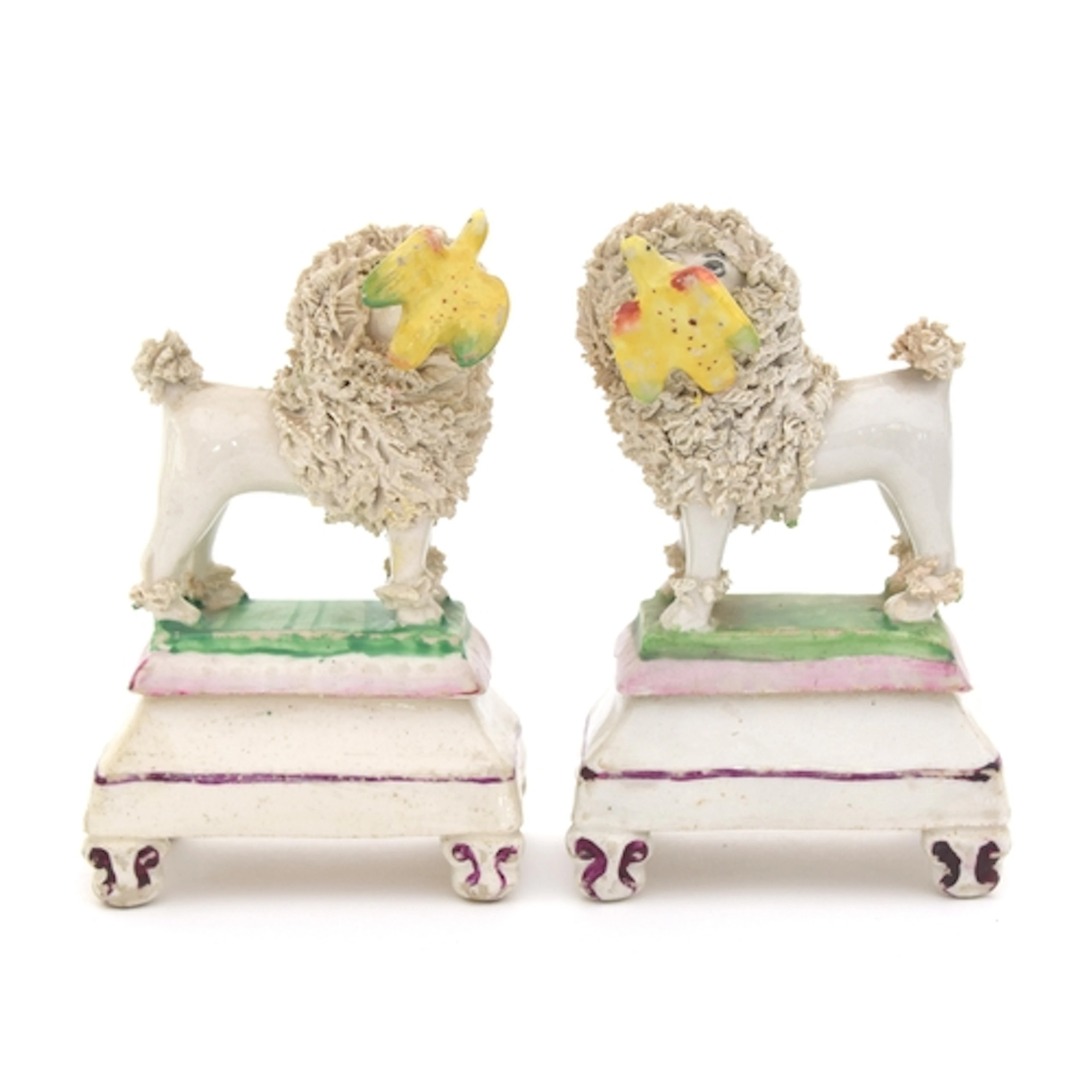 A pair of 19th century Staffordshire porcelain poodle figure...