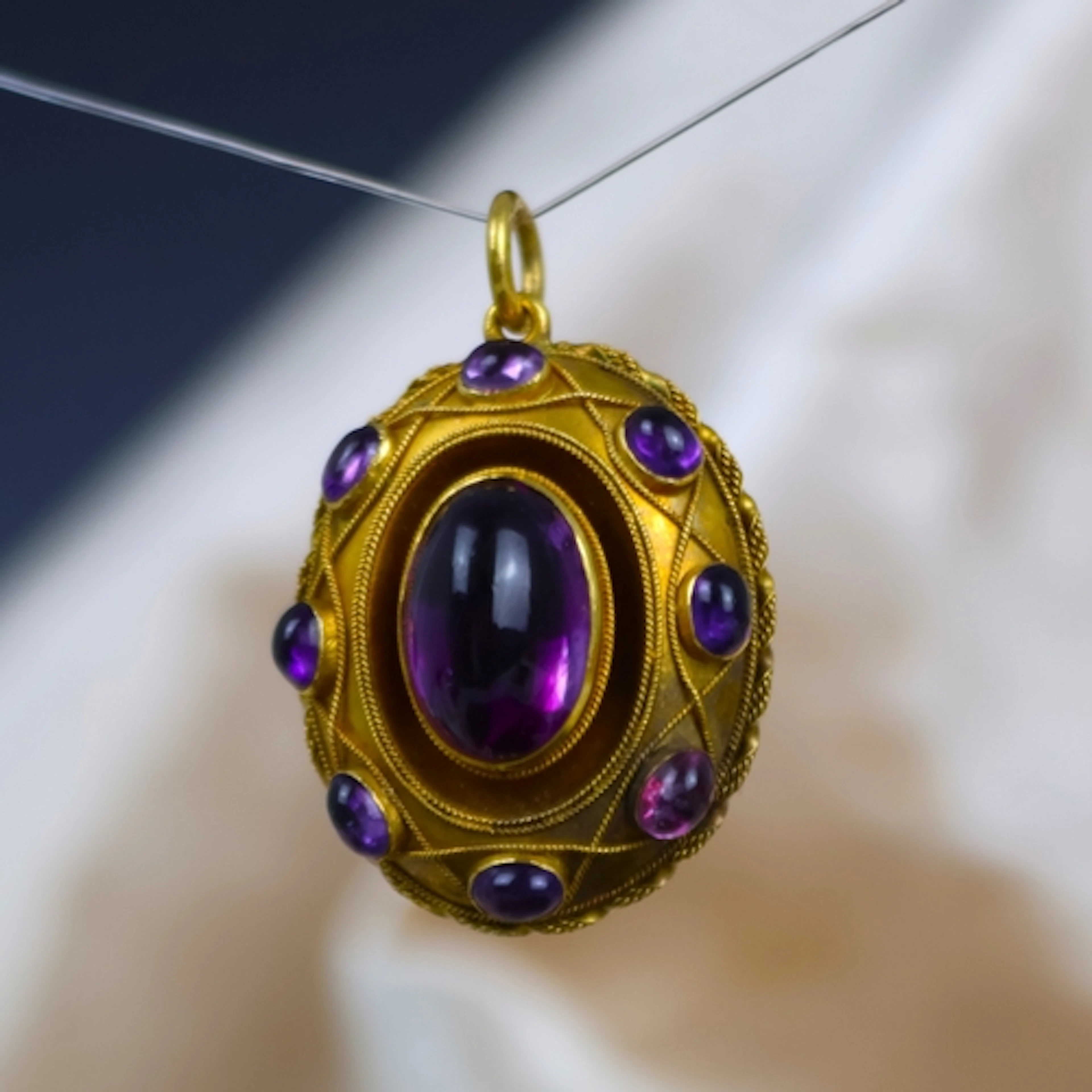 A 19th century Etruscan revival foil backed pendant/locket, ...