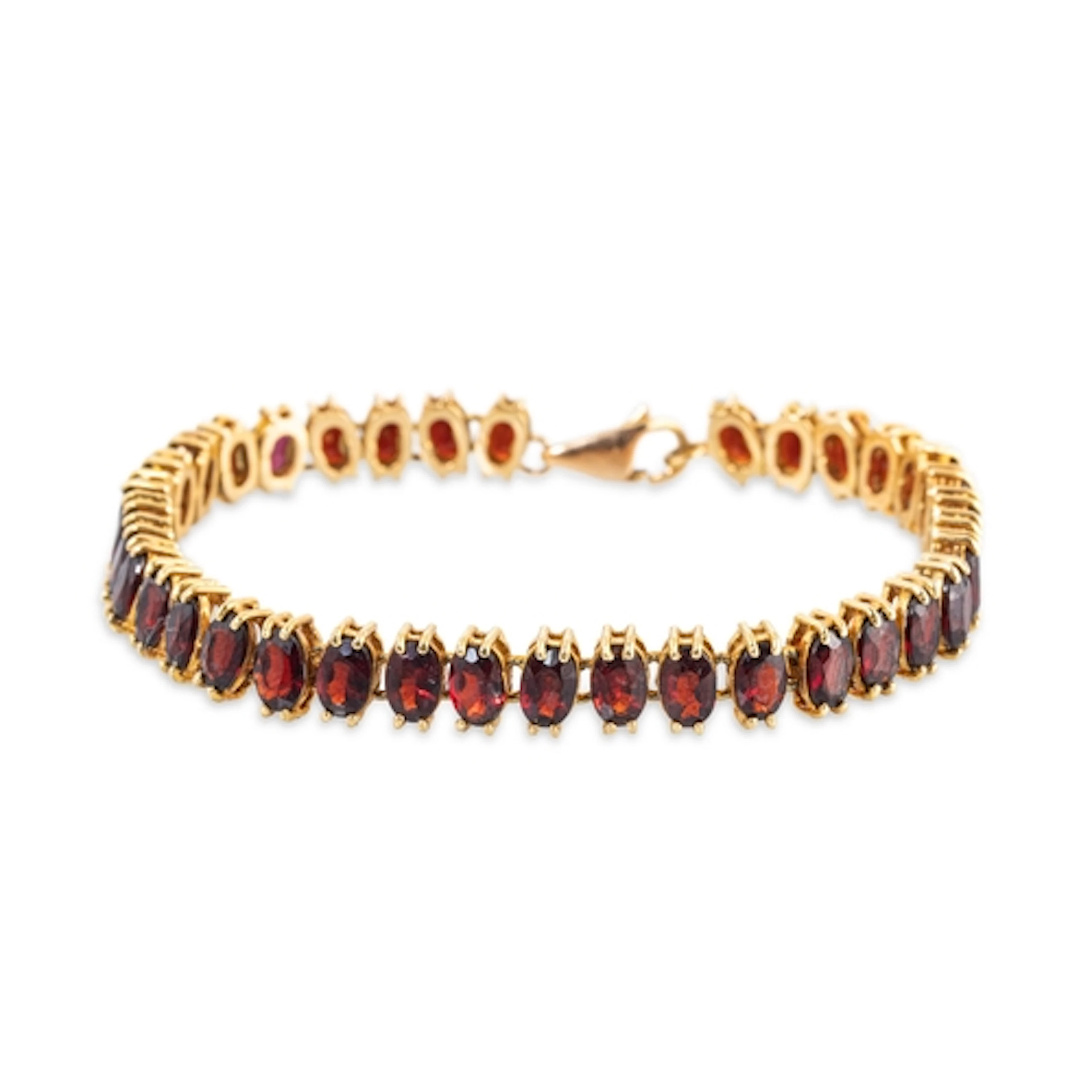 A GARNET SET BRACELET, mounted in unmarked yellow gold, test...