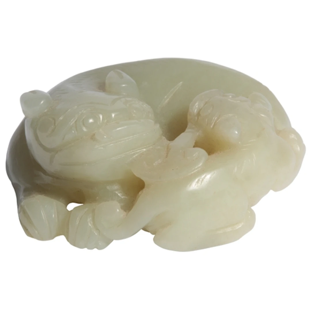 A Chinese pale celadon jade lion-dog group, 19th century, th...