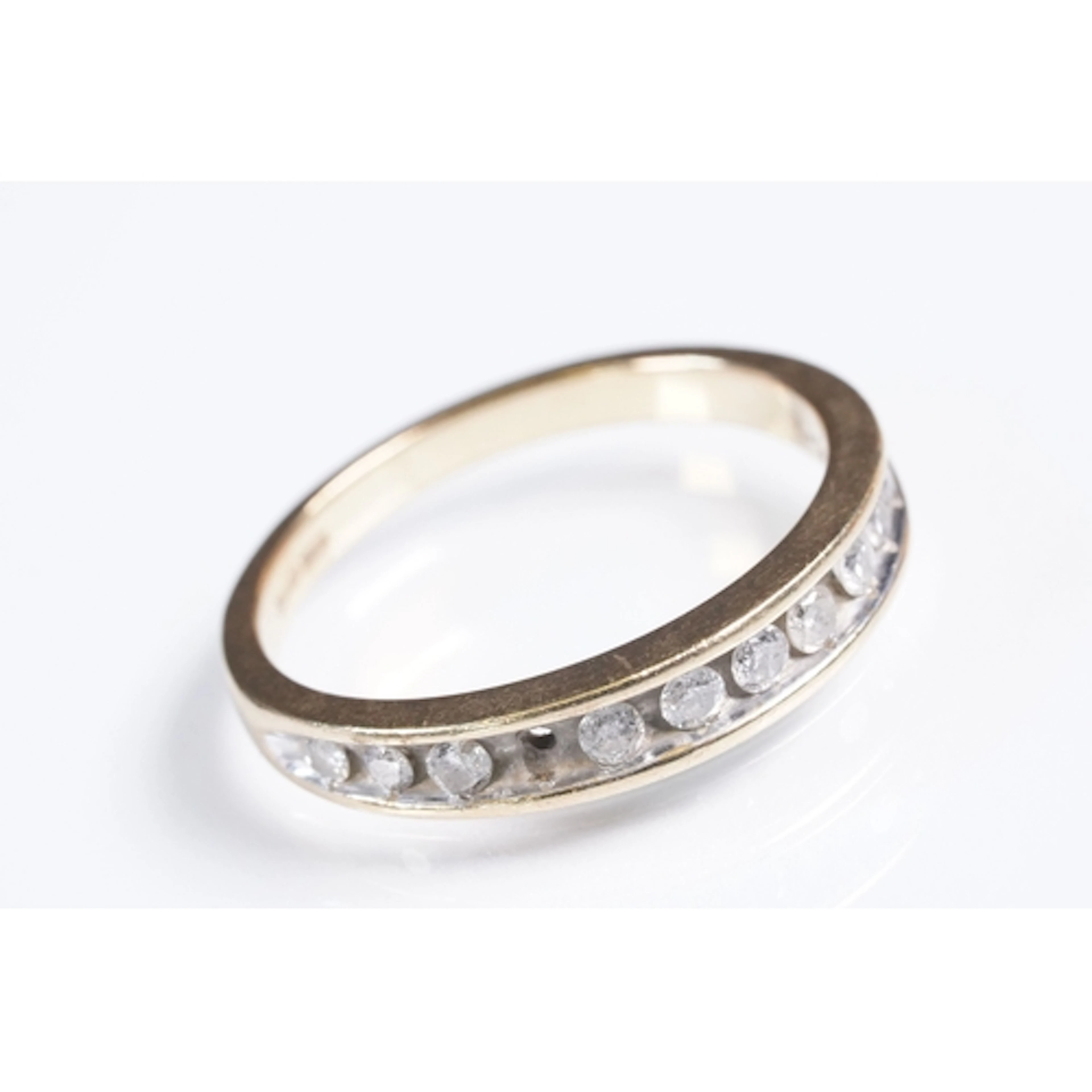 9ct gold and diamond half eternity ring being channel set wi...