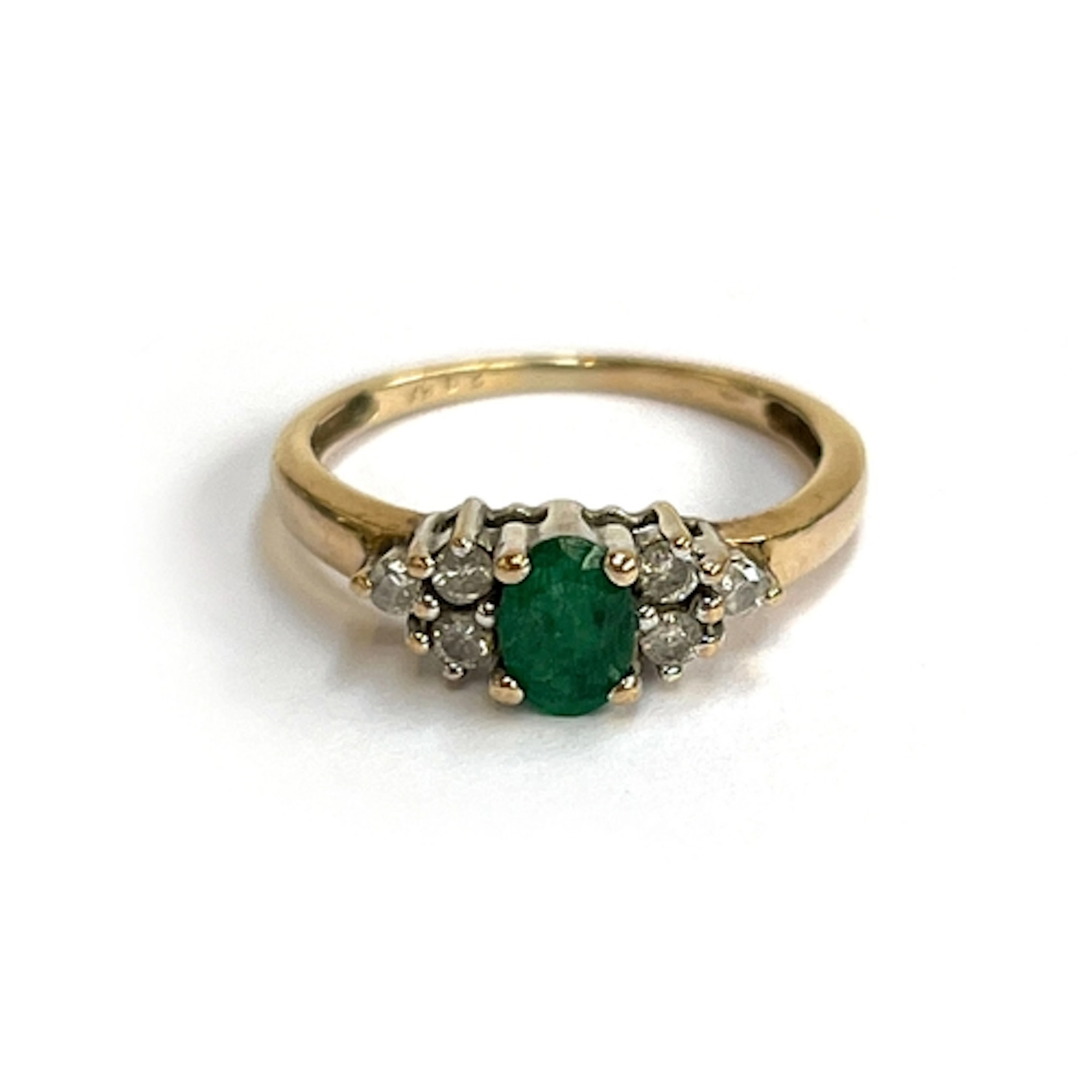 A 9ct gold ring set with an emerald and diamonds, size M 1/2...
