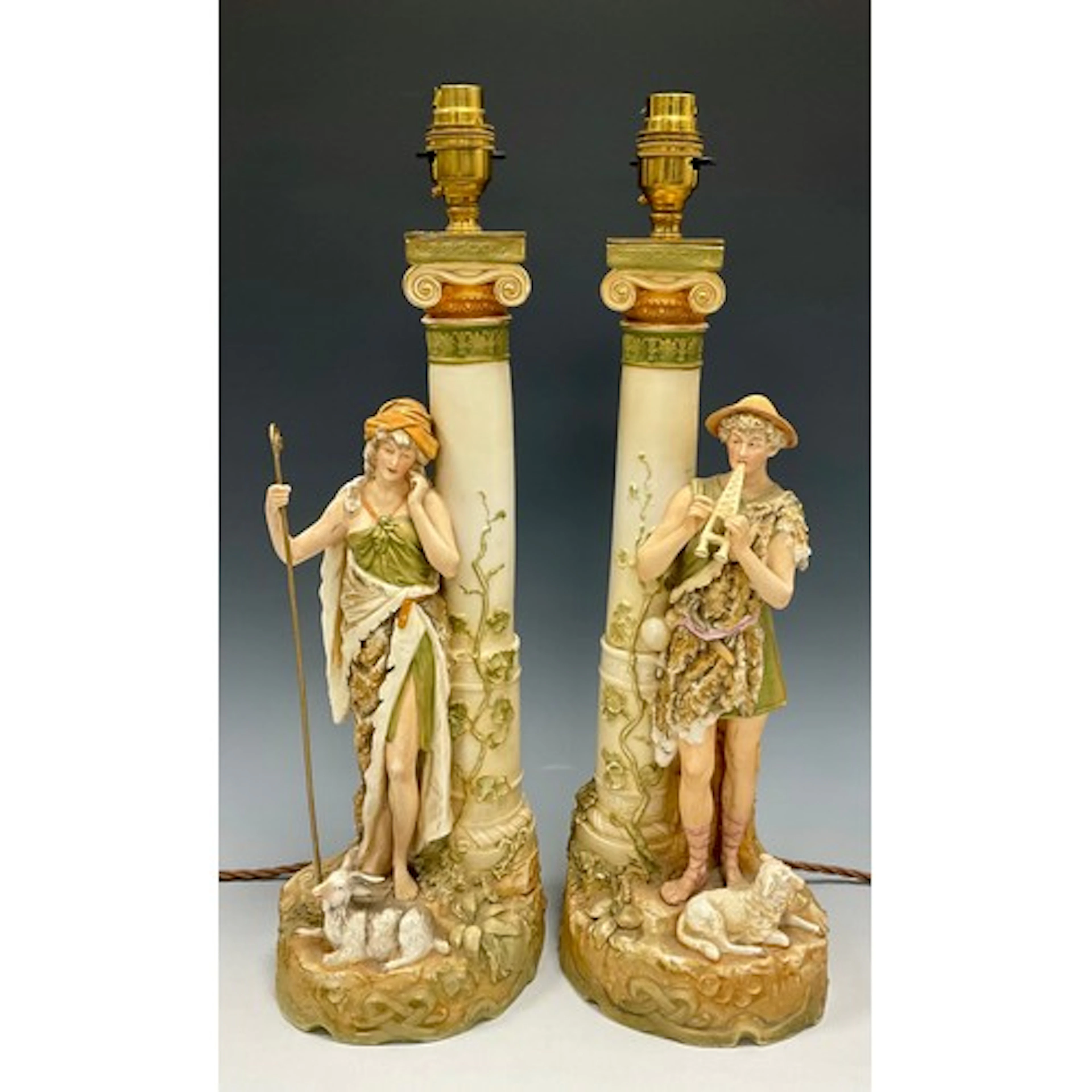 A pair of Royal Dux candlestick table lamps each modelled as...